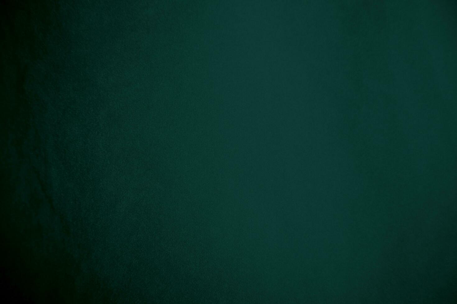 Green velvet fabric texture used as background. Emerald color panne fabric background of soft and smooth textile material. crushed velvet .luxury emerald tone for silk.. photo