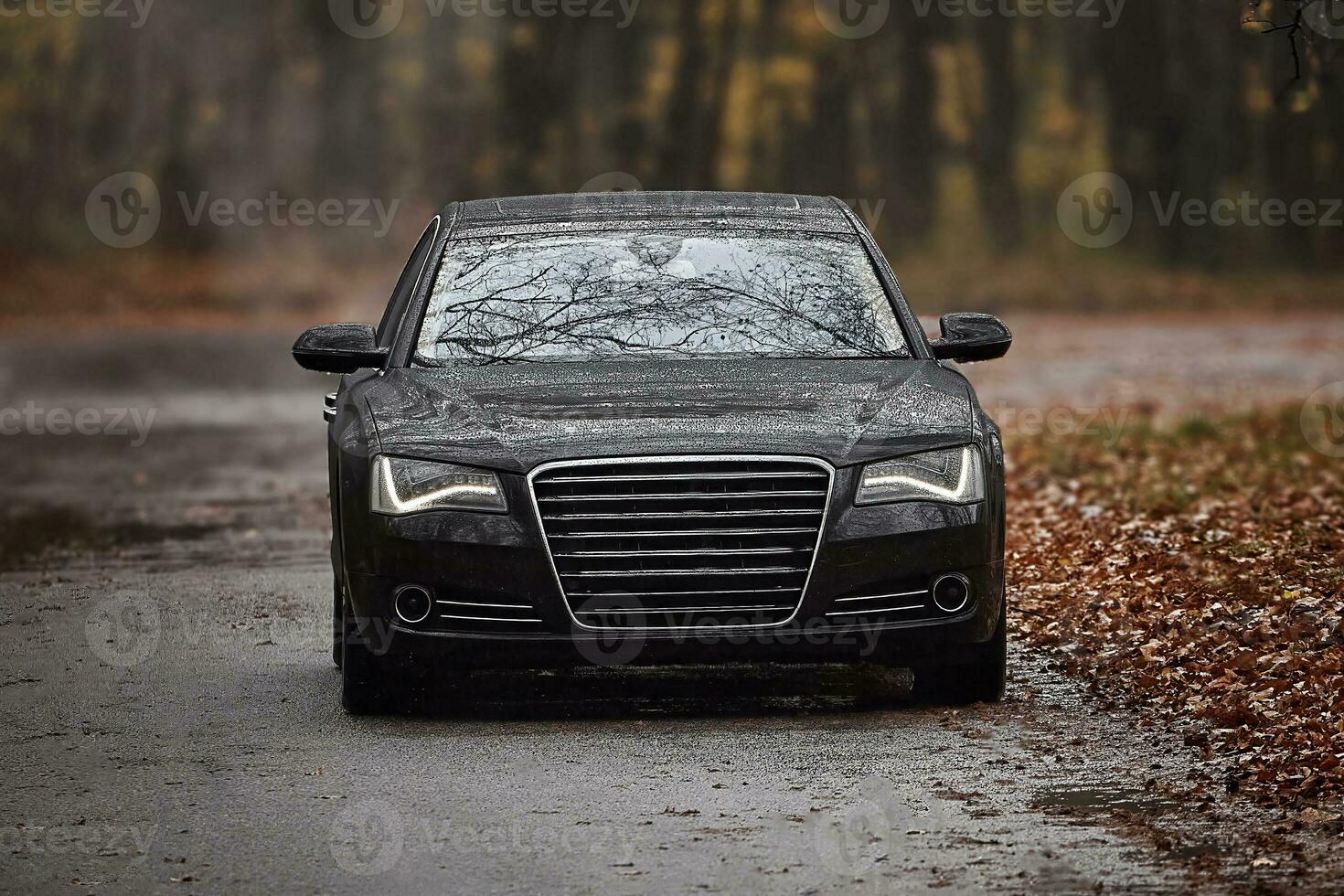 Modern black car driving on the road,  city car background photo