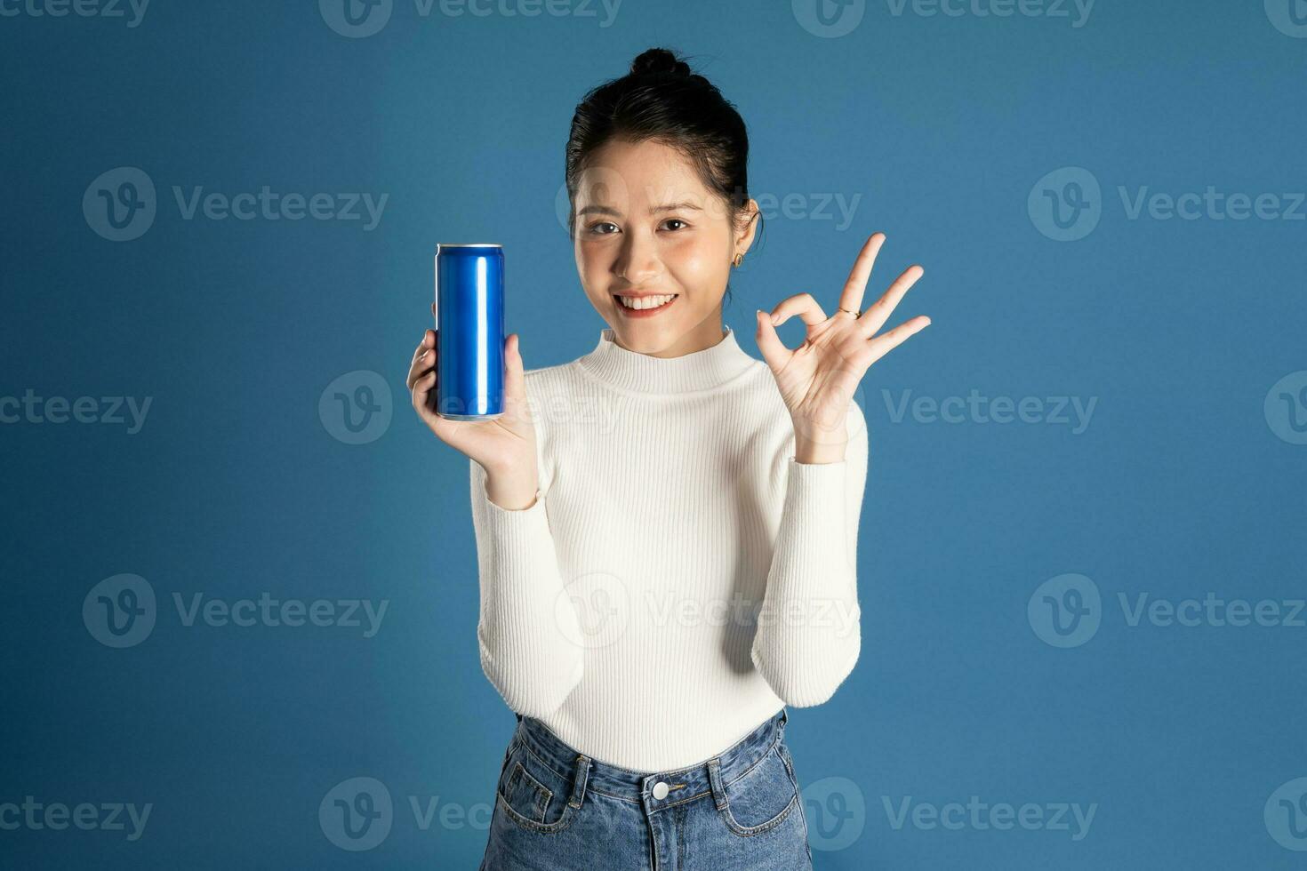 Portrait of beautiful asian girl posing on blue background photo