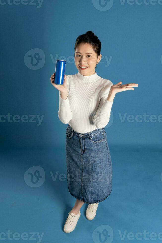 Portrait of beautiful asian girl posing on blue background photo