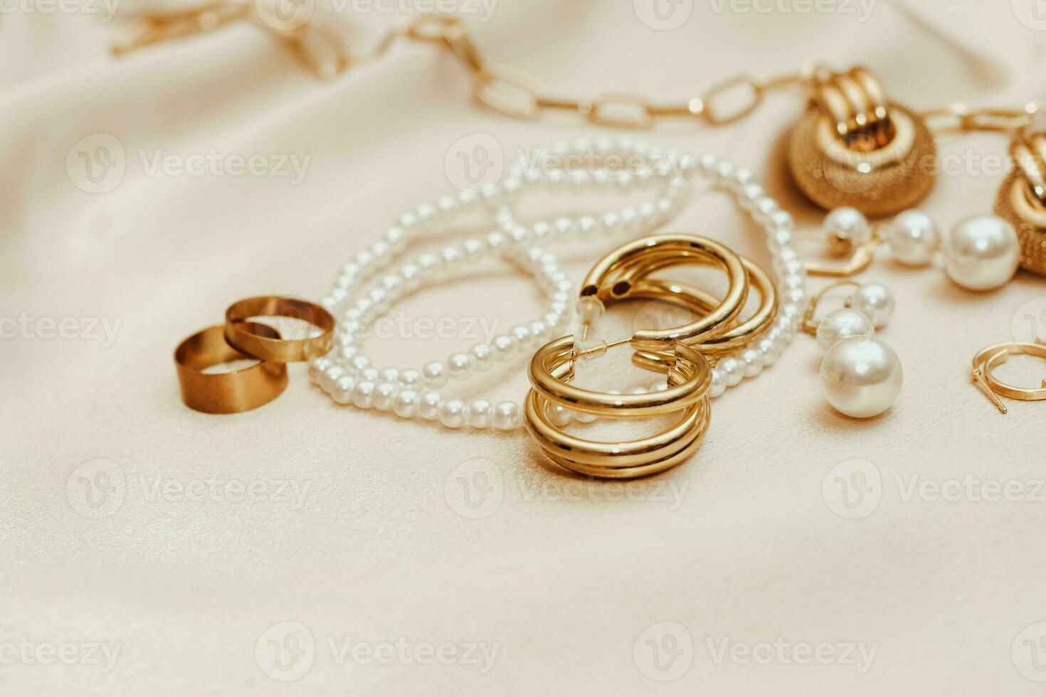 Women's jewelry, gold chain, trendy jewelry on a silk background. photo