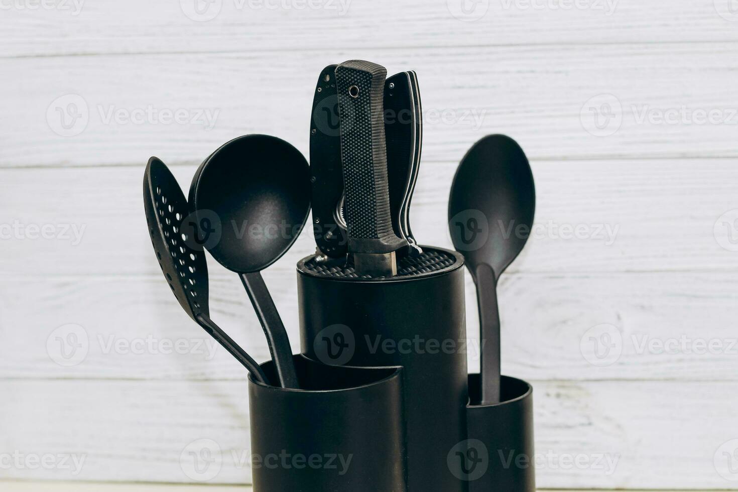 Kitchen tools plastic for multicooker on a wooden table in a dish organizer. photo