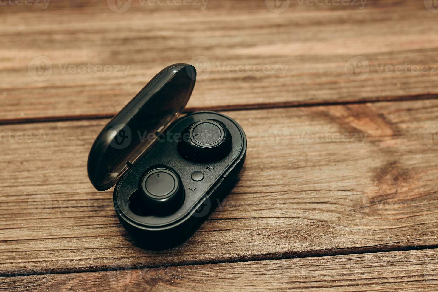 Wireless headphones in a black box on the table. photo