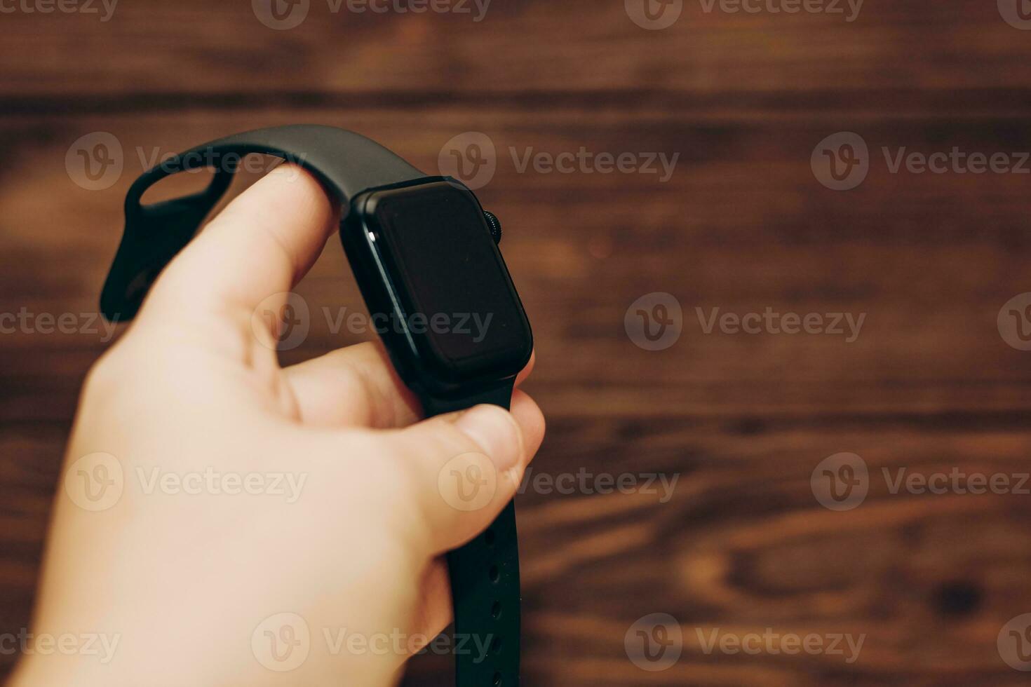Black technological smart watch in hand. photo