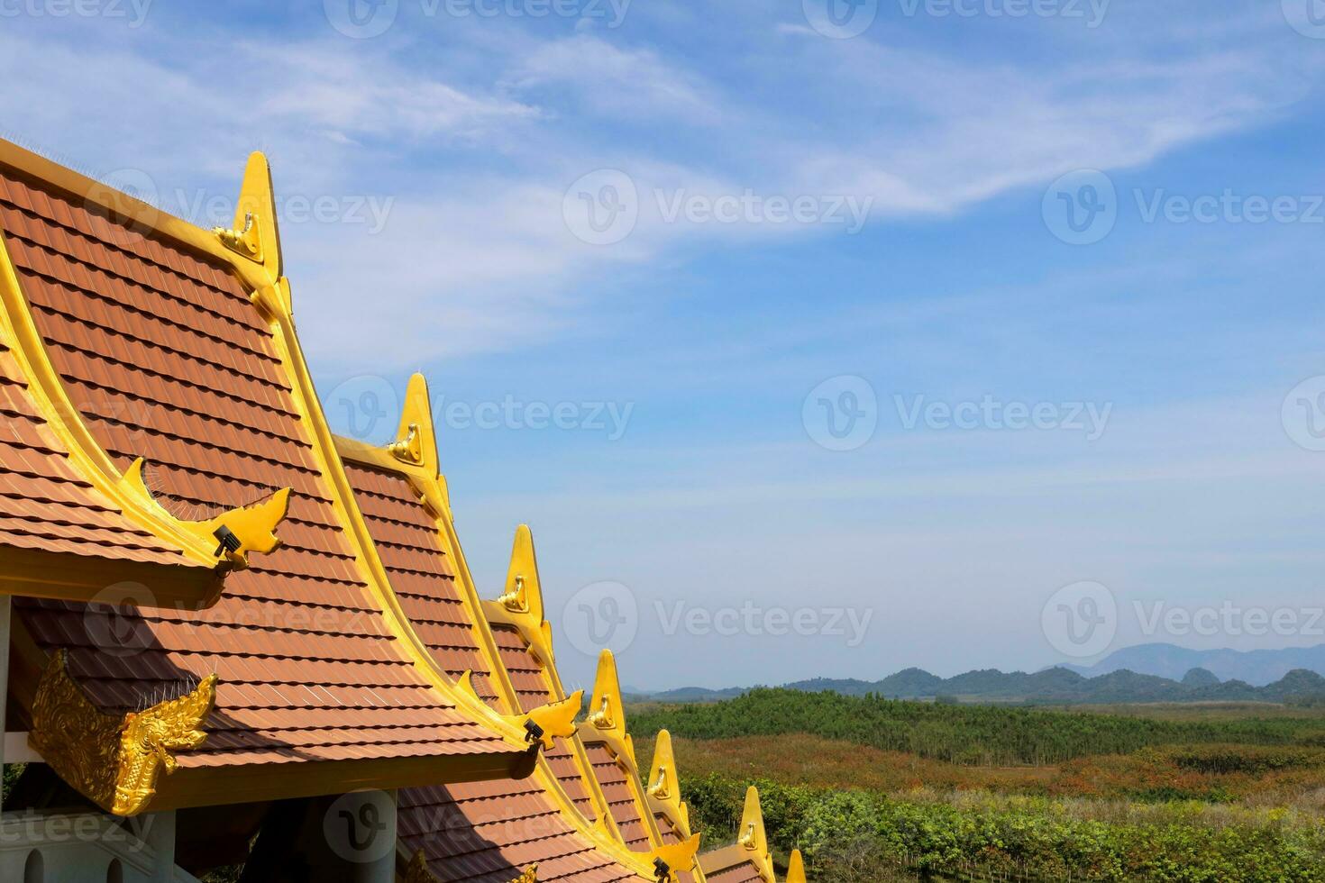 Close up Thai traditional style rooftop of walkway in Buddhism temple with bright blue sky, soft cloud. photo