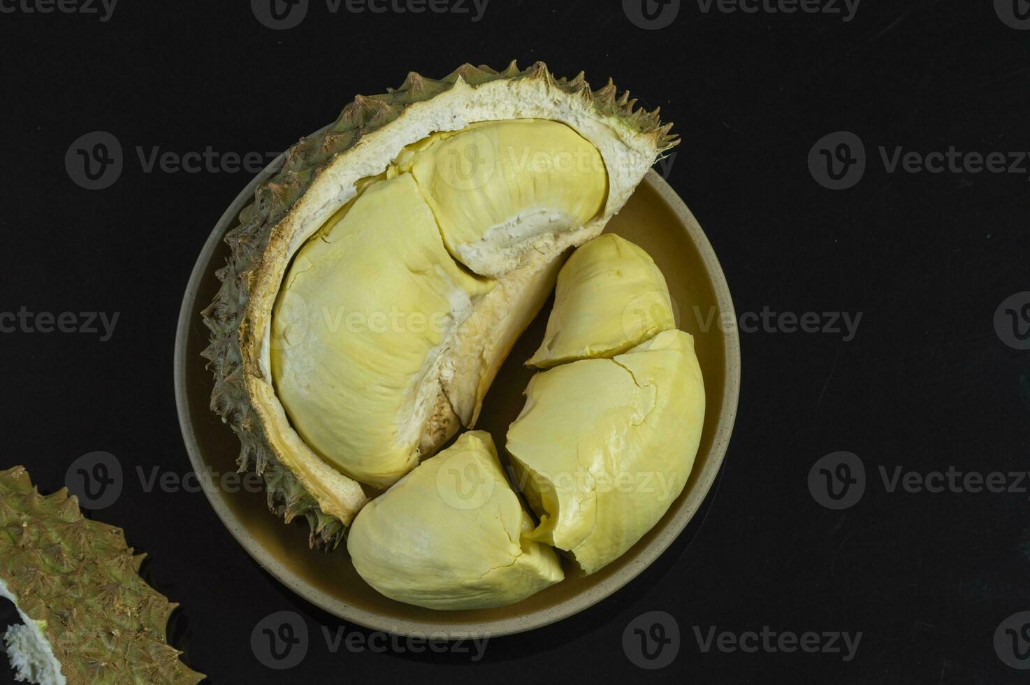 a durian fruit is cut in half photo