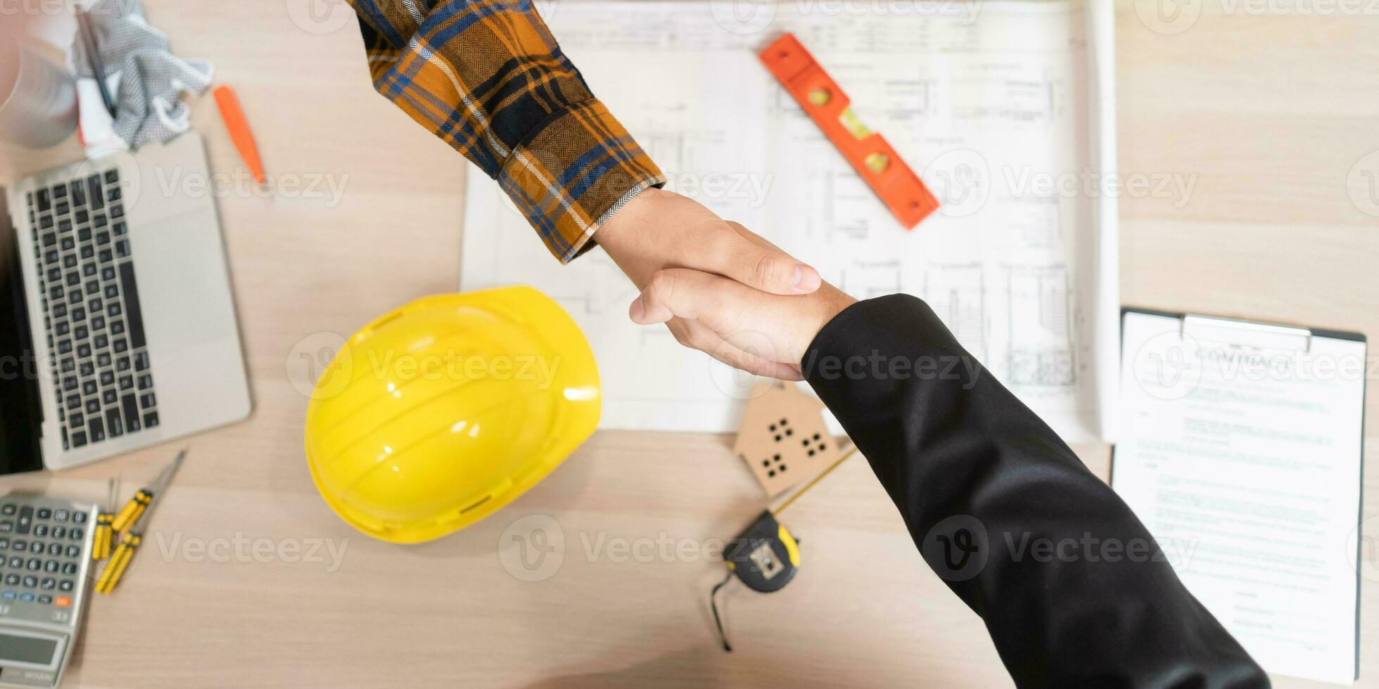 Construction team hands shaking greeting start up plan new project contract in office center at construction site, industry ,architecture, partner, teamwork, agreement, property, contacts. photo