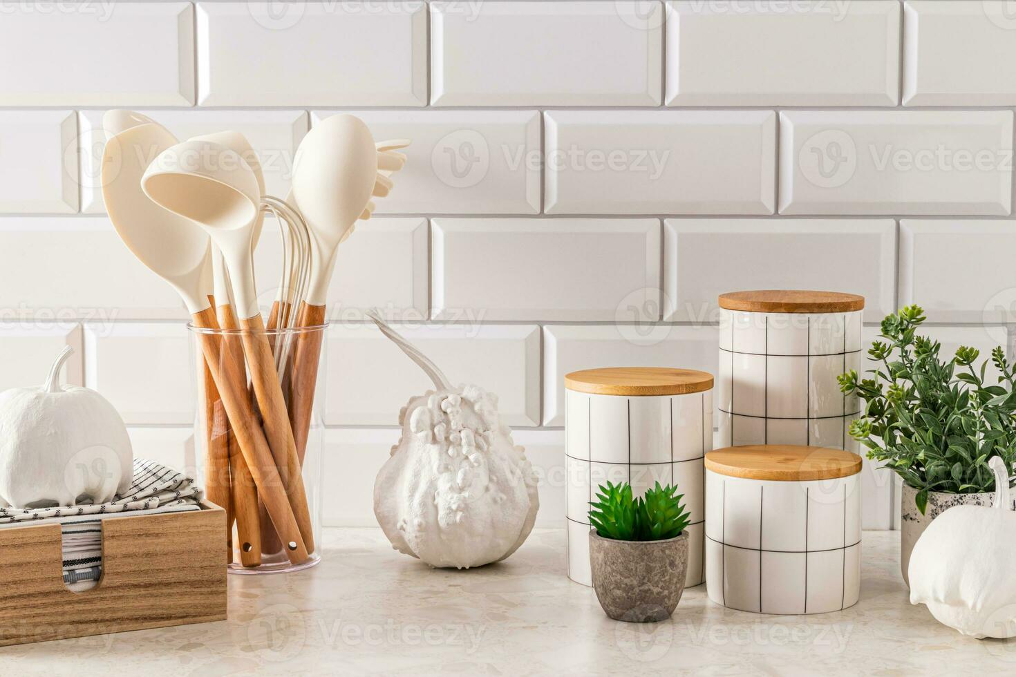 Modern kitchen background with elements of natural decor, white decorative pumpkins. Stylish jars for storage. Towel in a wooden box. photo