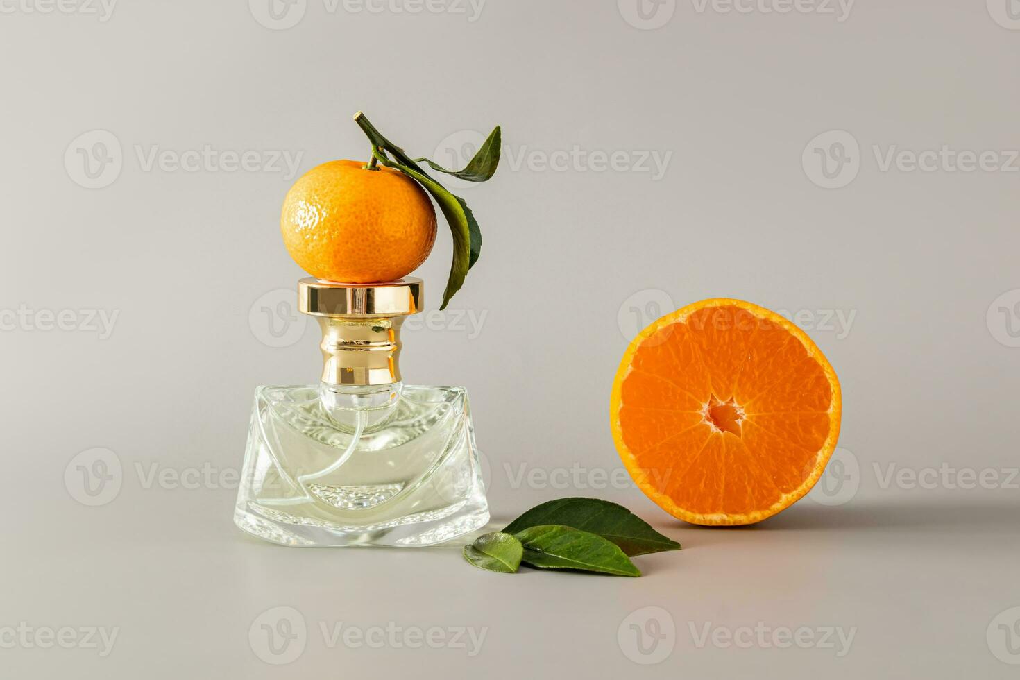 A chic bottle of women's perfume with a delicate aroma with notes of tangerine on a pastel background with ripe fruit. An original smell of freshness photo