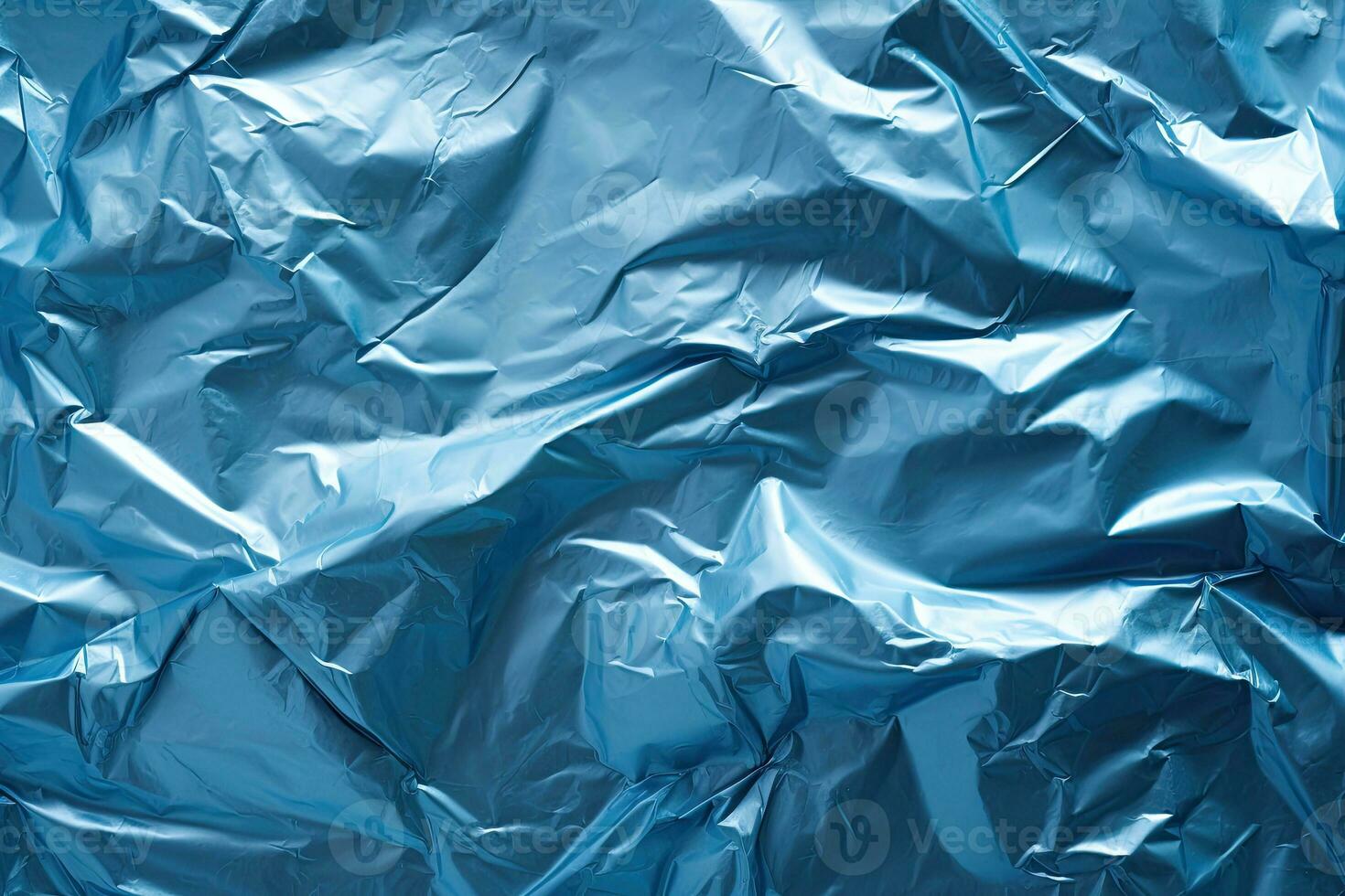 blue plastic wrap overlay backdrop. crumpled and draped textured cellophane material photo