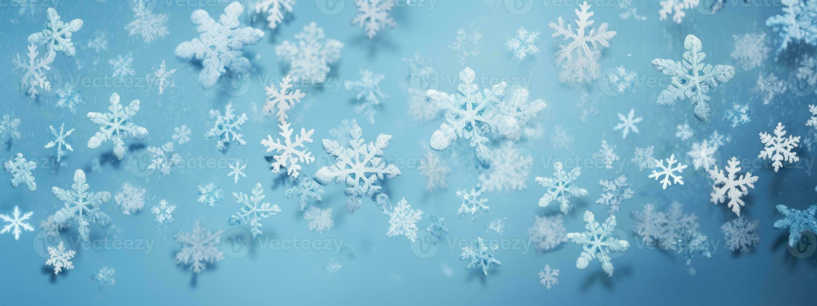 falling snowflakes and ice flakes on a light blue winter backdrop photo