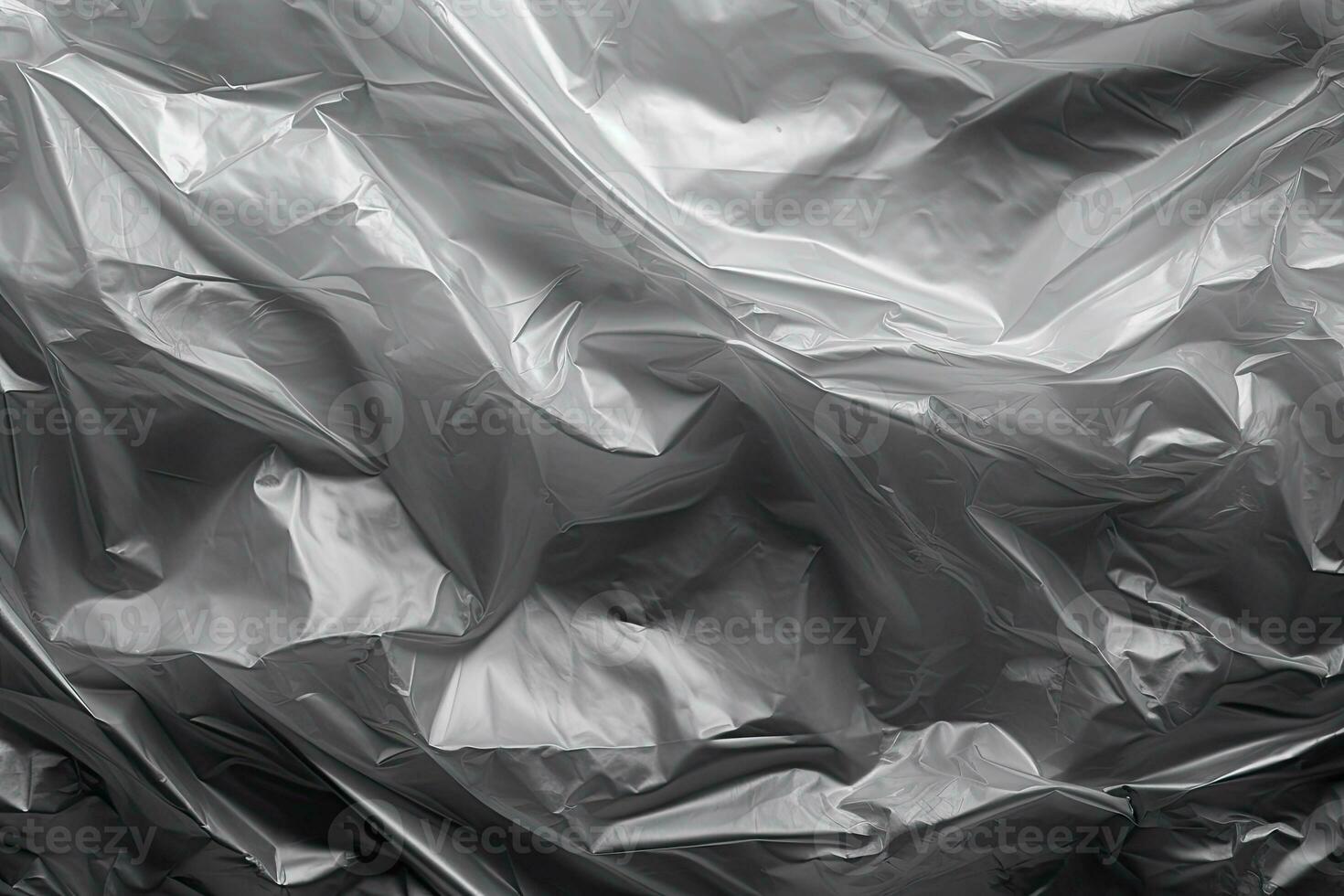 gradient gray plastic wrap overlay backdrop. crumpled and draped textured cellophane material photo