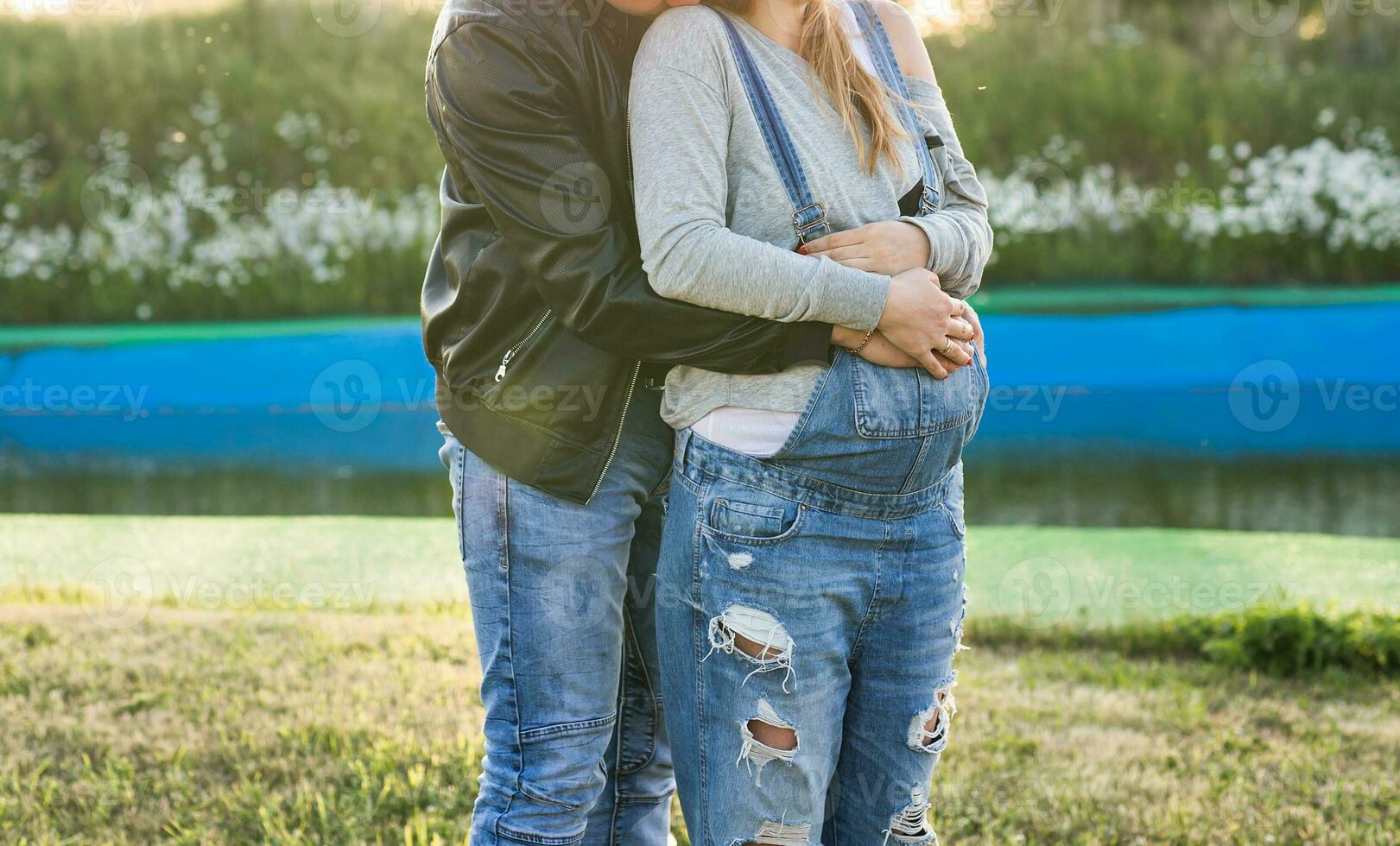 Happy smiling future parents on the walk in autumn park photo