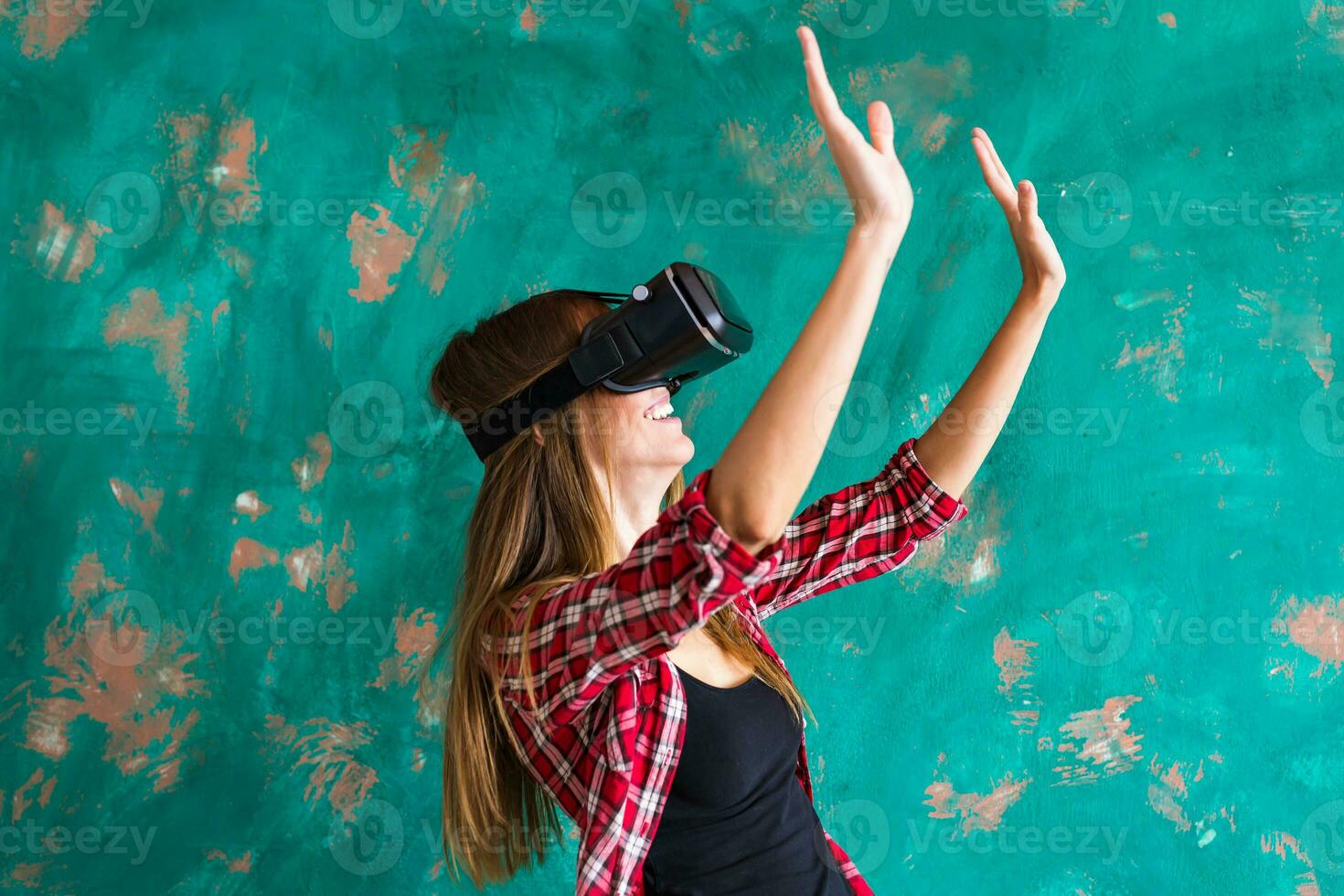 Smile happy woman getting experience using VR-headset glasses of virtual reality much gesticulating hands photo