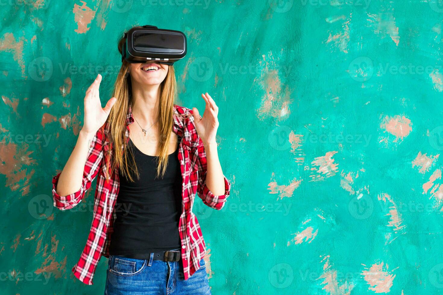 Smile happy woman getting experience using VR-headset glasses of virtual reality much gesticulating hands photo