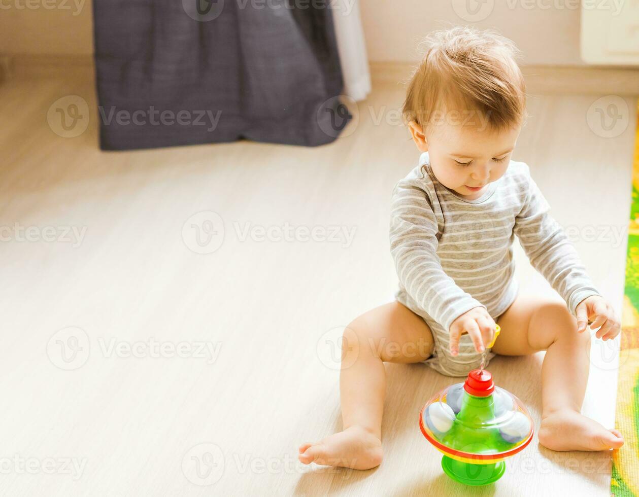 baby boy playing with toy indoors at home photo