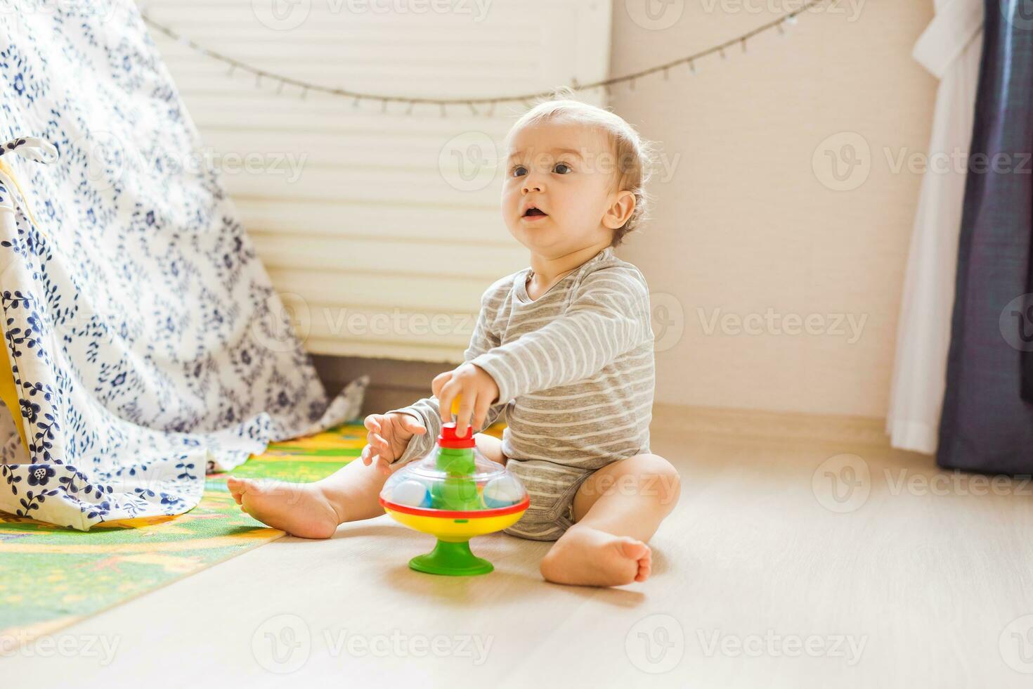 baby boy playing with toy indoors at home photo