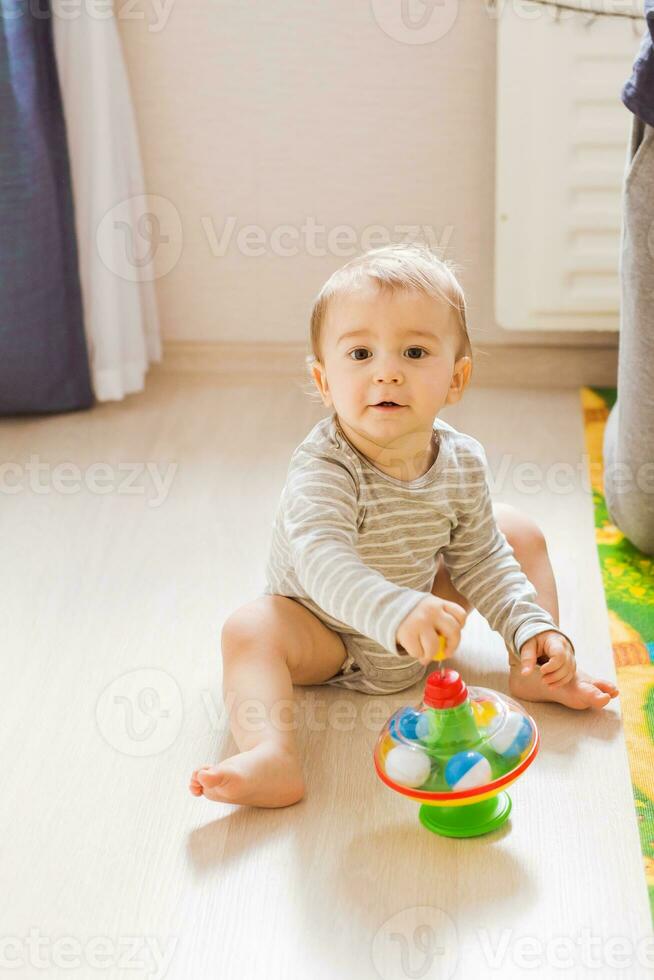 Baby boy plays in his room. photo