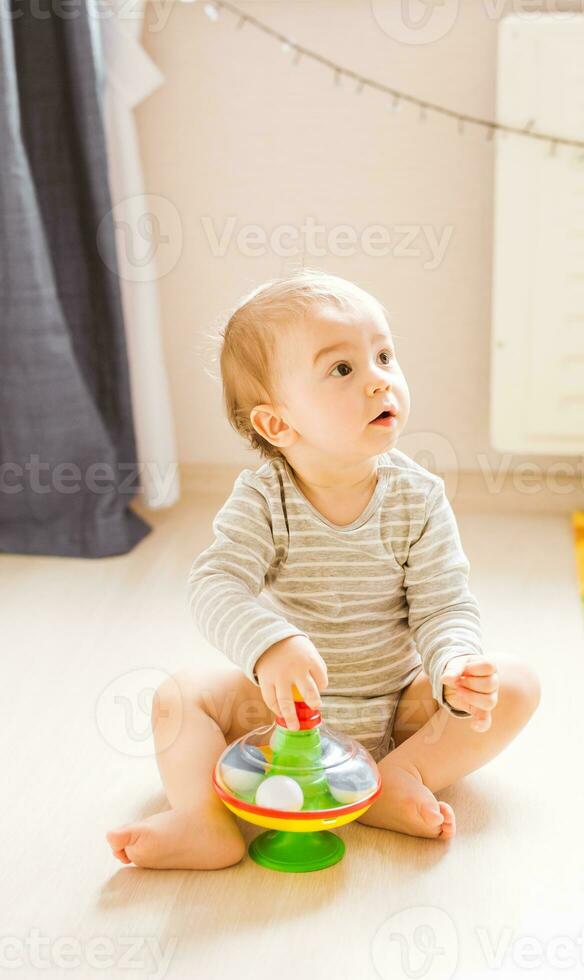 Baby boy plays in his room. photo