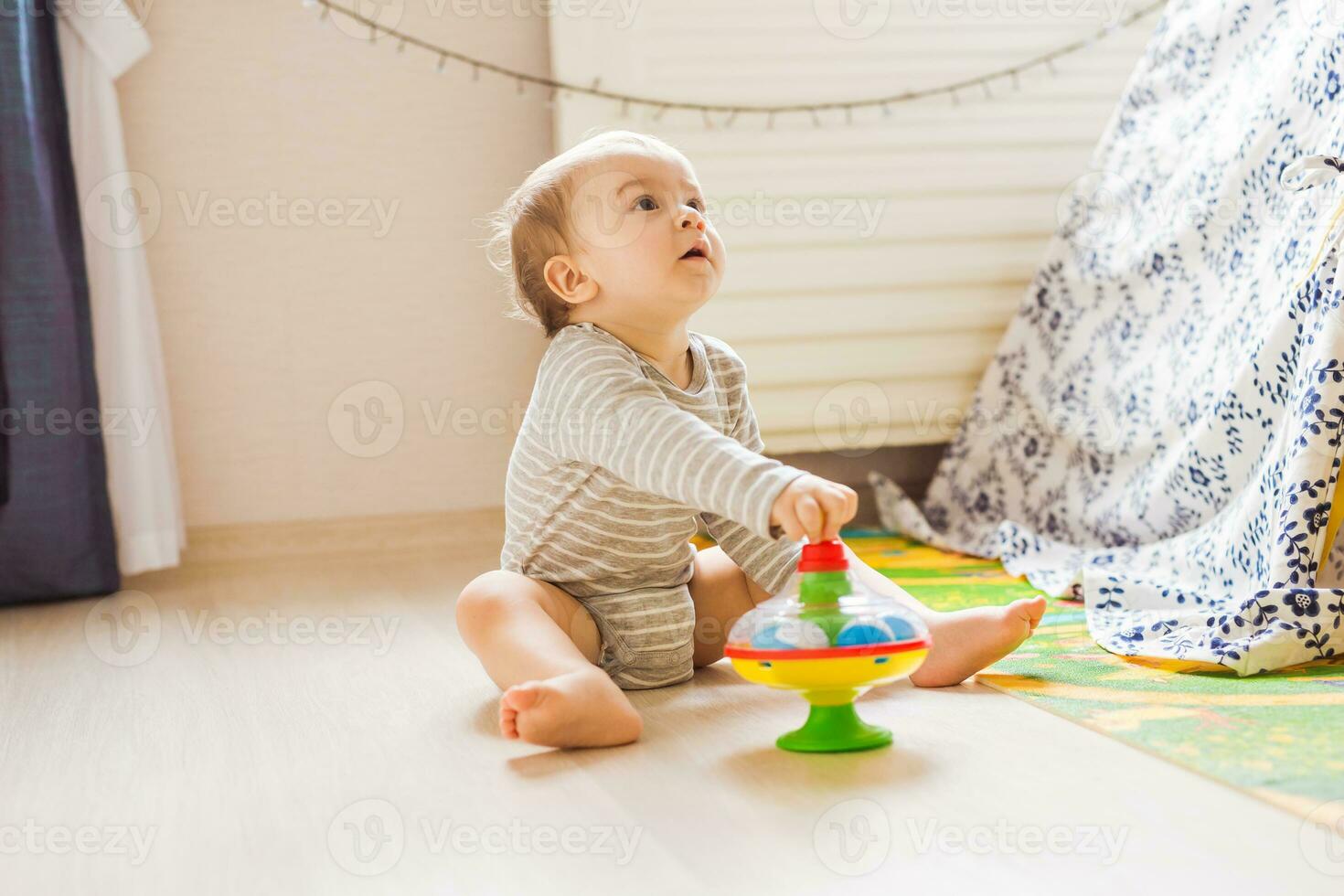 Baby boy plays in his room. photo