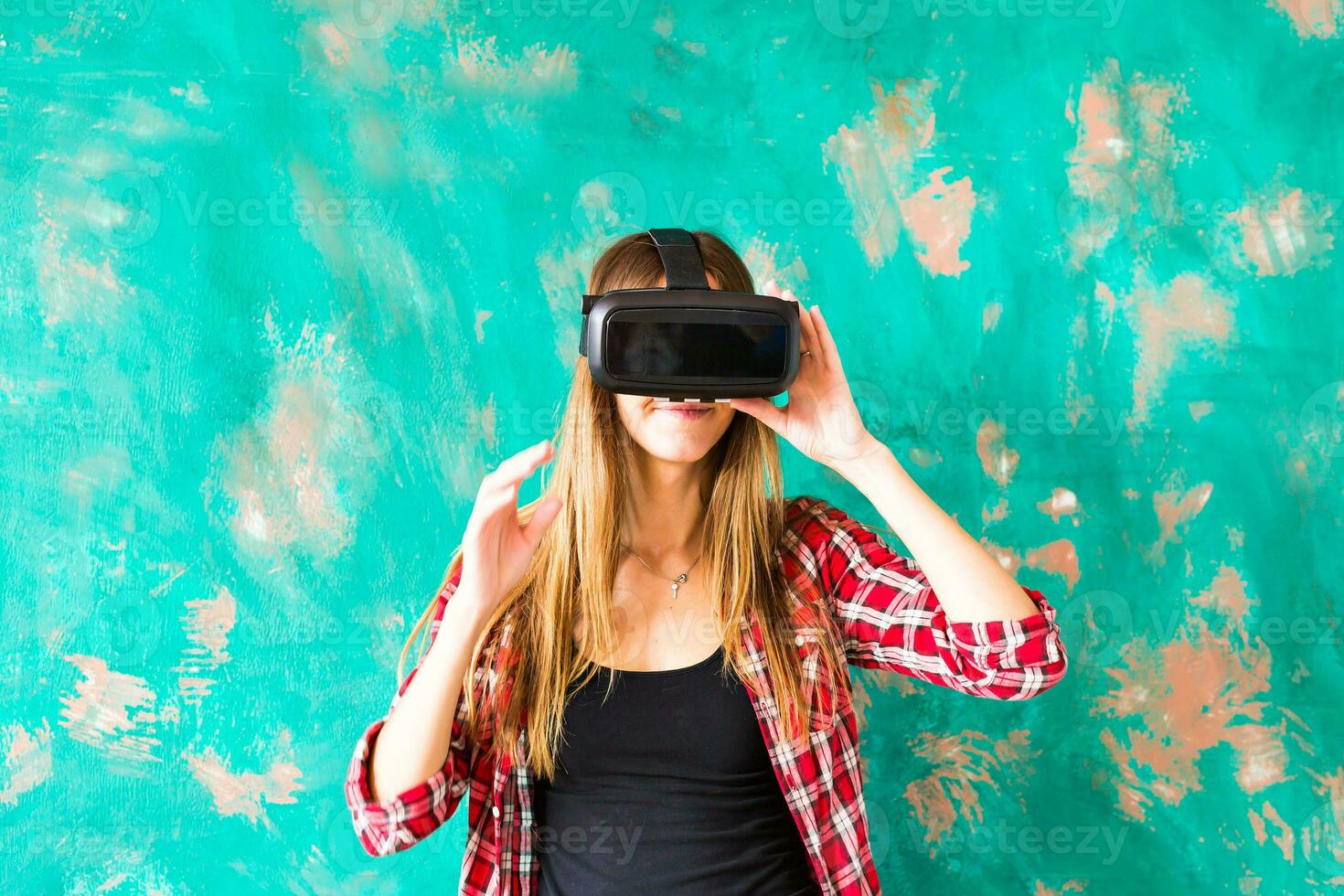 Smile happy woman getting experience using VR-headset glasses of virtual reality much gesticulating hands photo