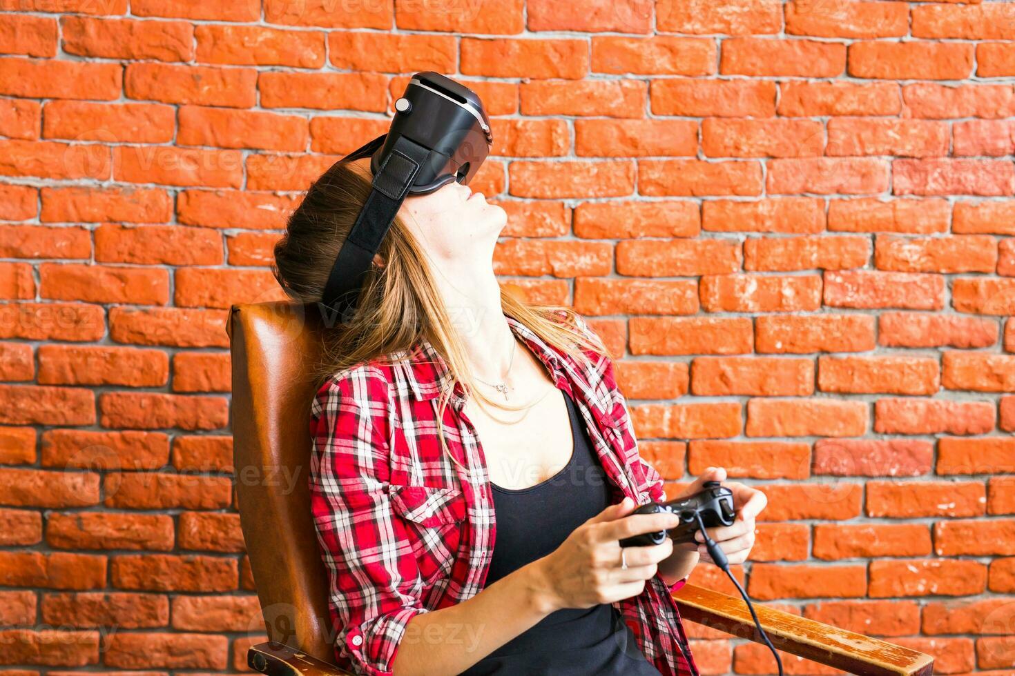 Smile happy woman getting experience using VR-headset glasses of virtual reality much gesticulating hands photo