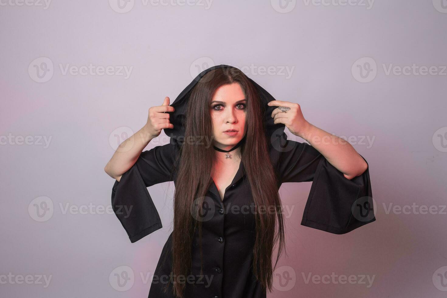 Gothic young woman in witch halloween costume photo