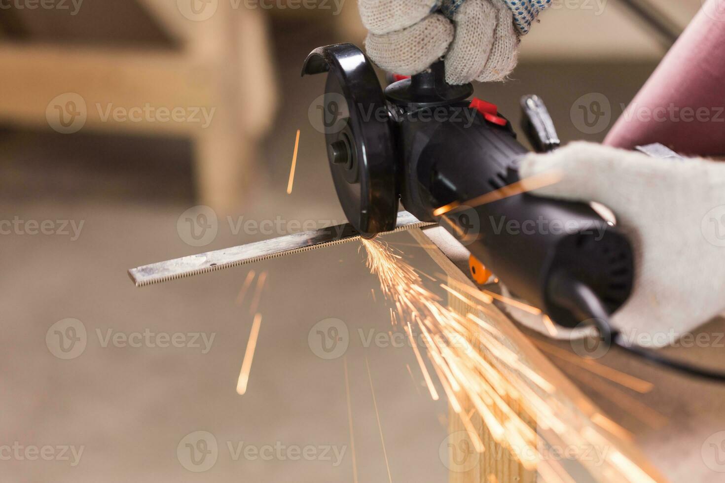 cutting metal with angle grinder, sparks from the disk. photo