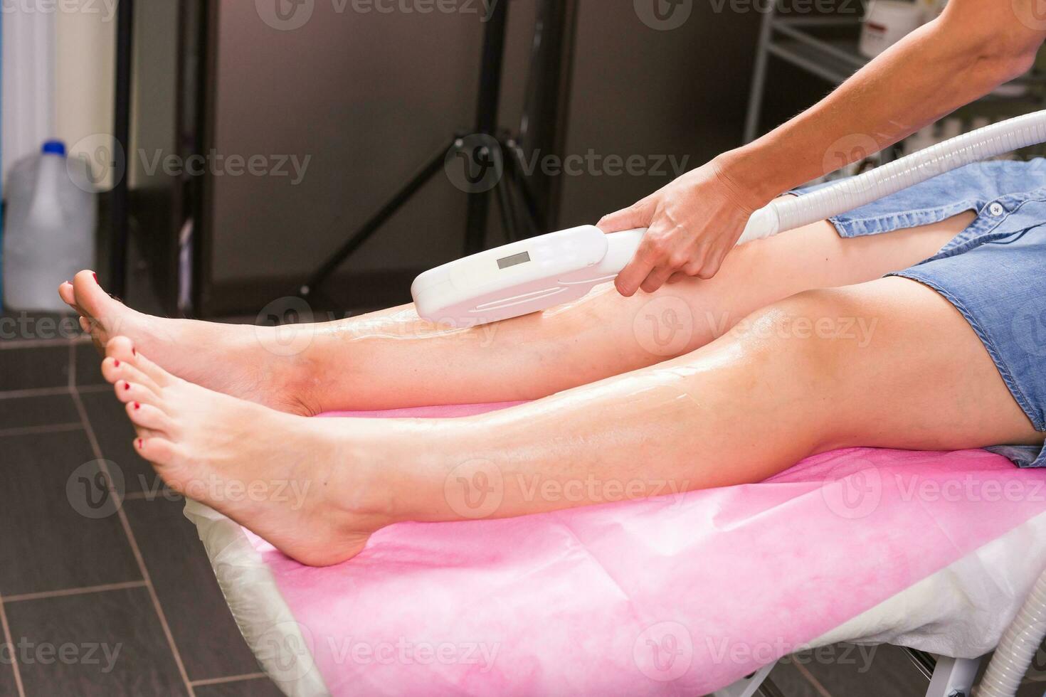Hair removal cosmetology procedure from a therapist at cosmetic beauty spa clinic. Laser epilation. Cosmetology and SPA concept. photo