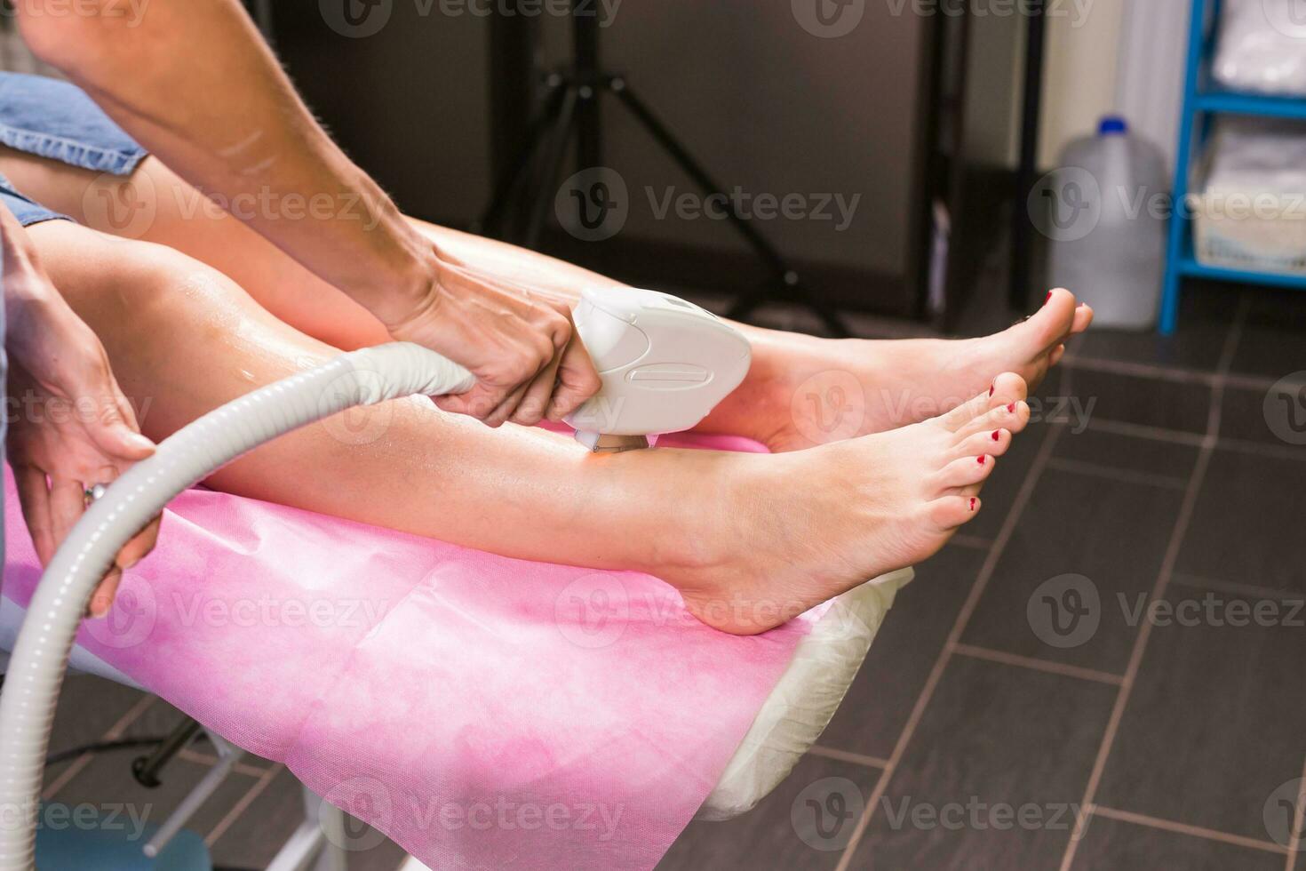 Hair removal cosmetology procedure from a therapist at cosmetic beauty spa clinic. Laser epilation. Cosmetology and SPA concept. photo