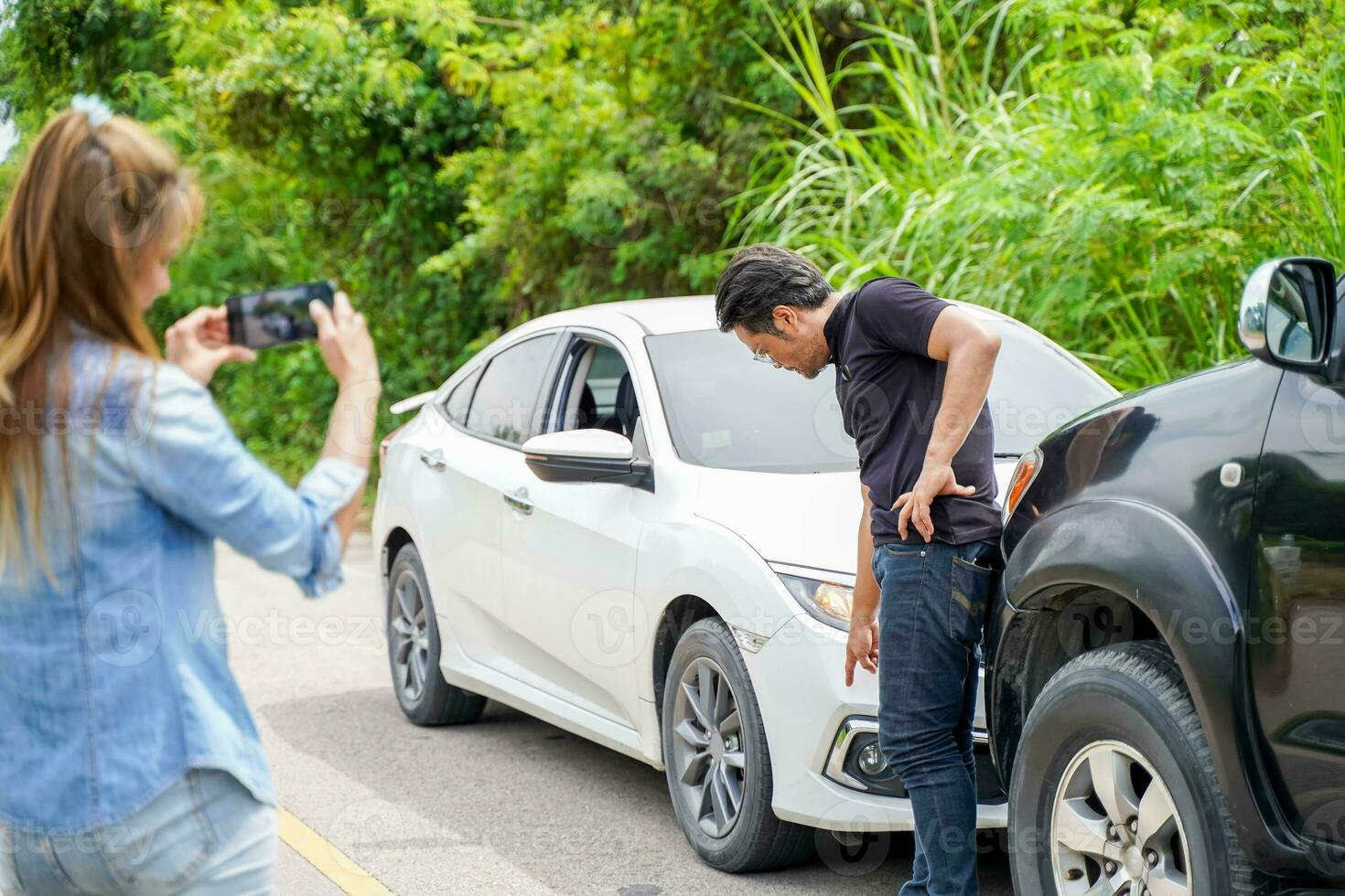 Closeup woman driver are using mobile phones to take photos as evidence for insurance claims with parties.