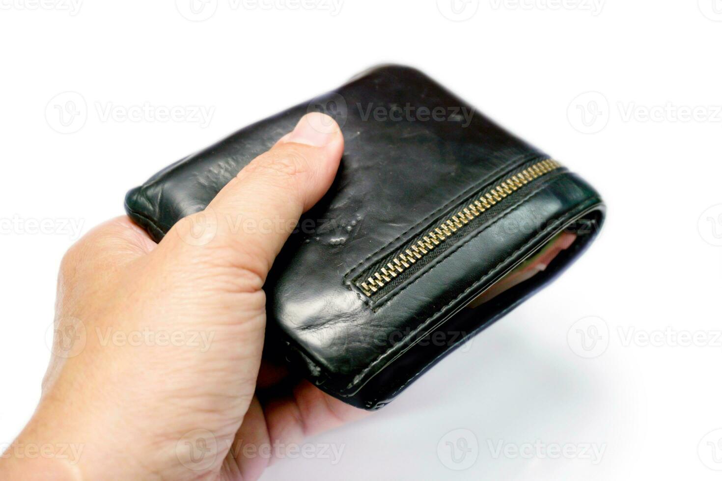 Closeup hand of human holding a black men's leather wallet isolate on white background and make with paths. photo