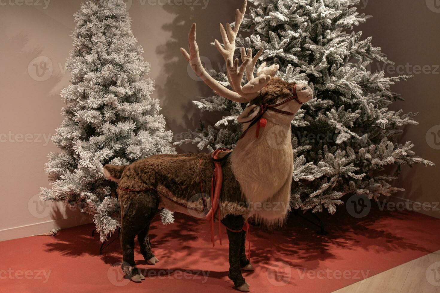 christmas decoration reindeer on the background of winter christmas trees photo