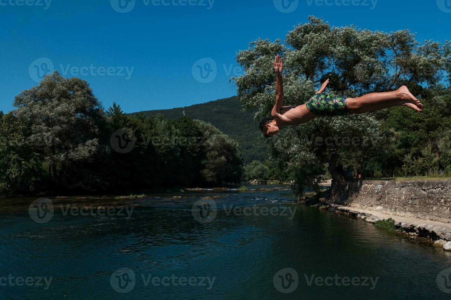 a man is standing on a wooden ledge photo