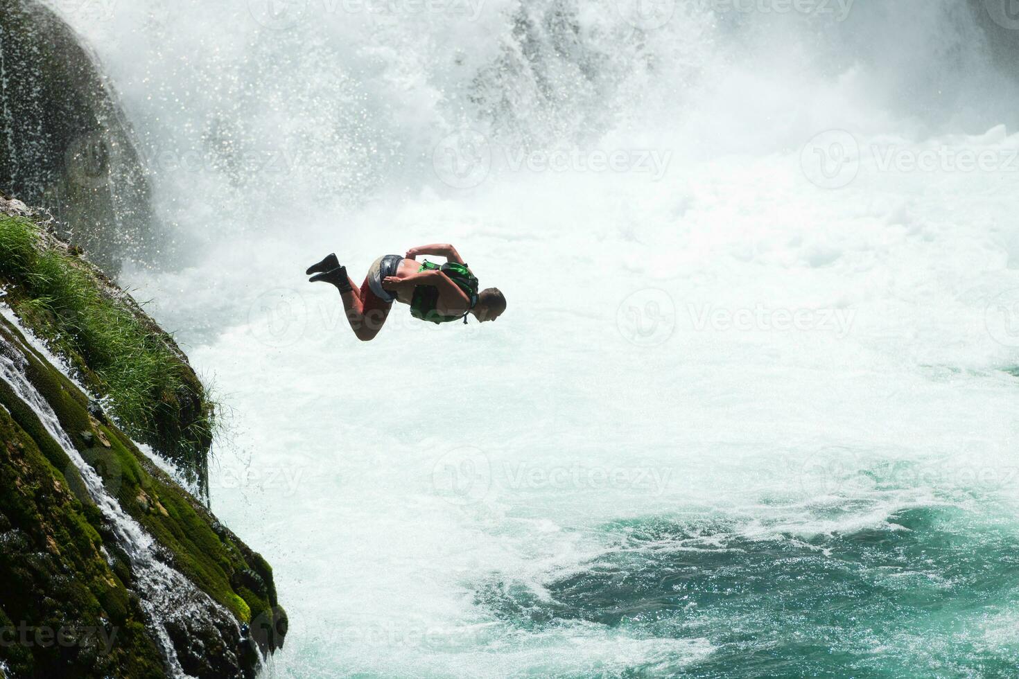 a man is standing on a wooden ledge photo