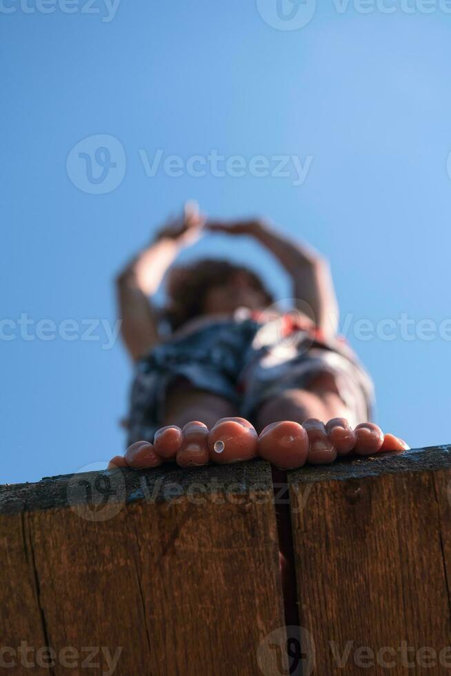 a man is standing on a wooden ledge photo