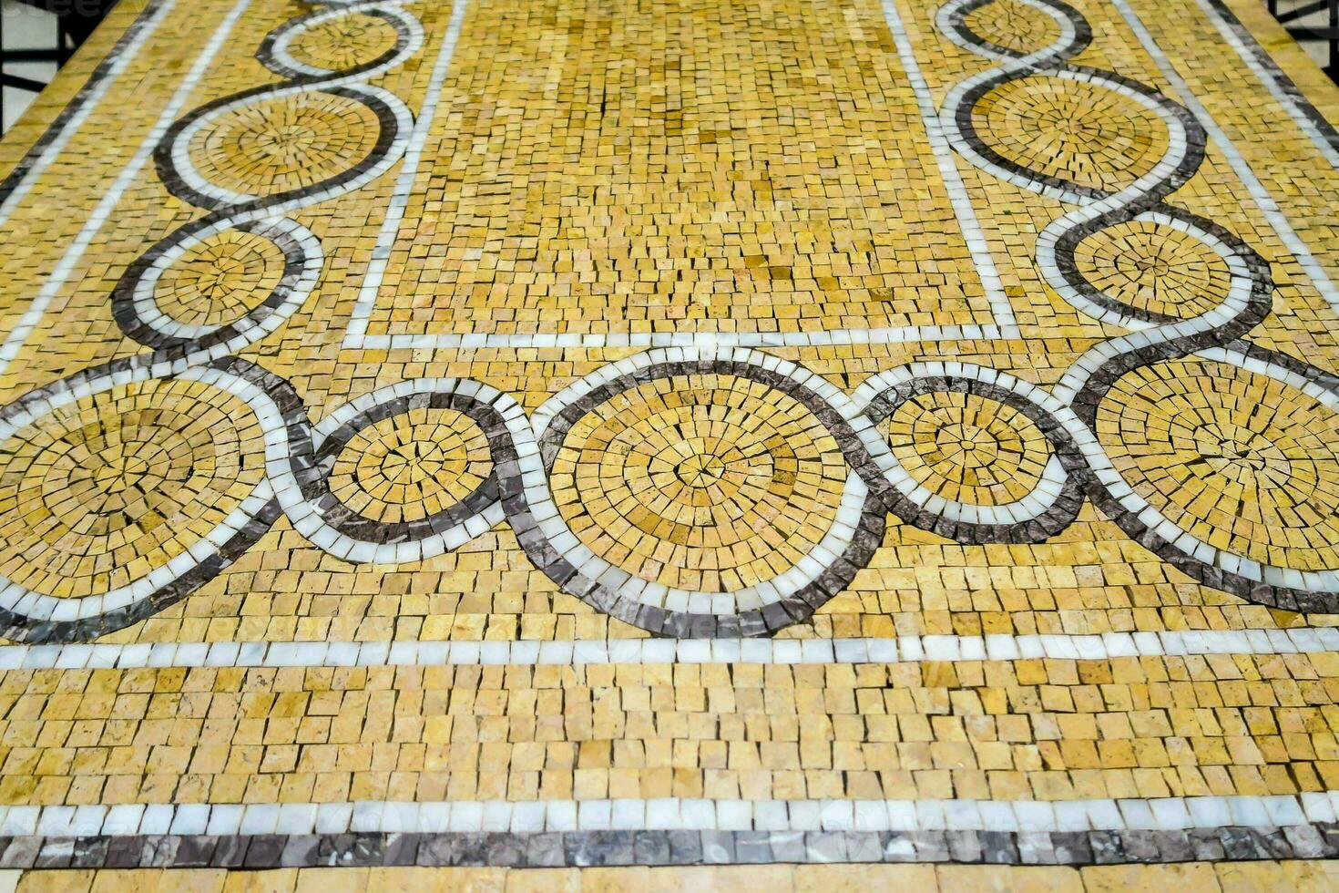 a mosaic floor with a circular design on it photo