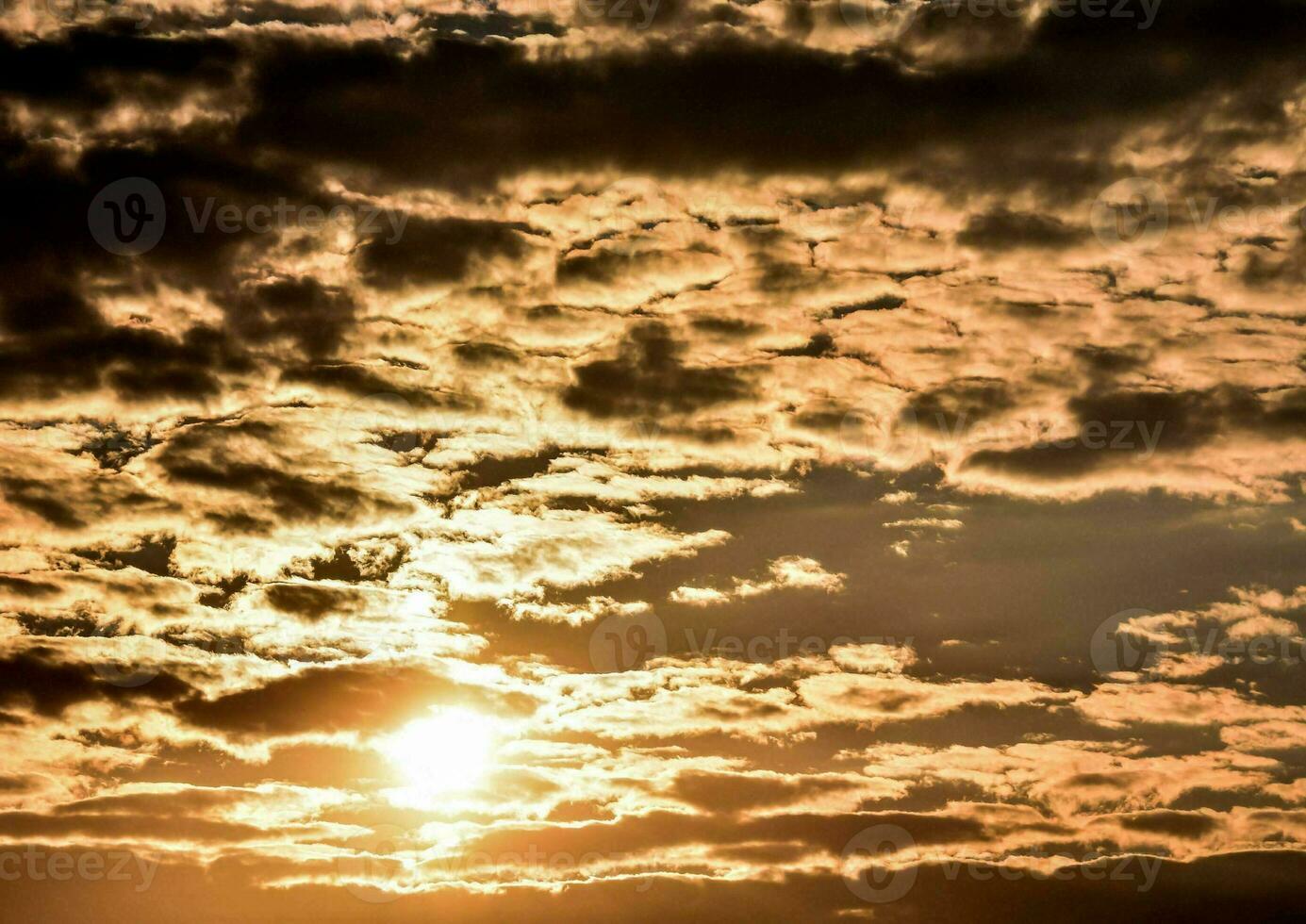 the sun is setting behind some clouds photo