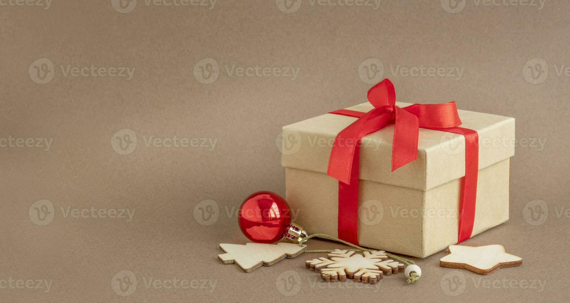 Christmas gift box with red ribbon and toys photo