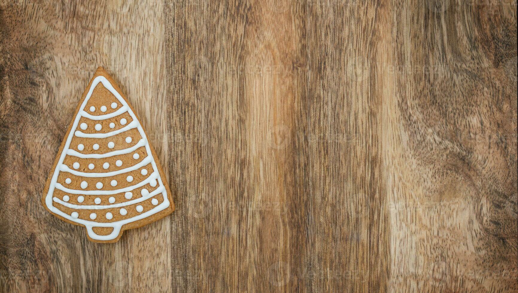 Concept Gingerbread Christmas tree on the wooden background photo