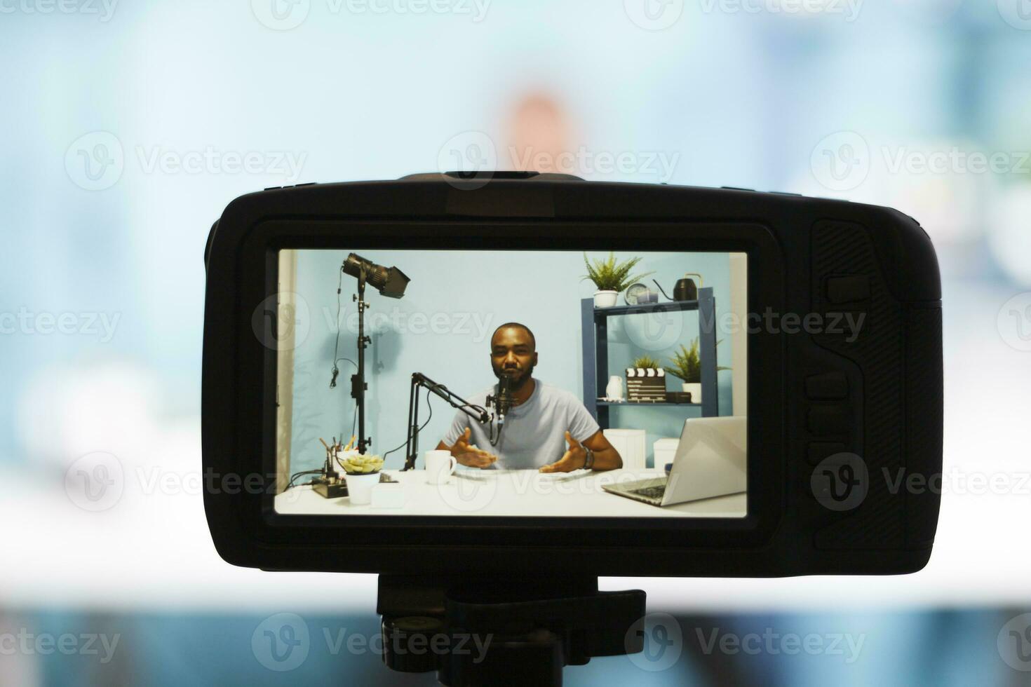 African american blogger on camera screen speaking to subscribers while recording video with professional equipment. Internet streamer talking in microphone while broadcasting live photo