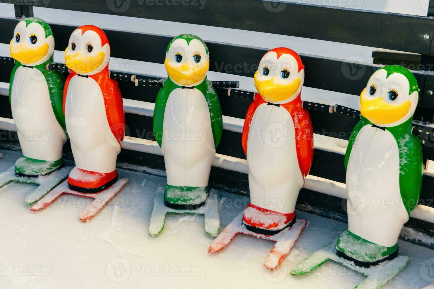 Shot of special equipment needed for skating, helping people to keep balance on ice rink. Helpers for skater beginners. Colourful figures in form of penguins photo