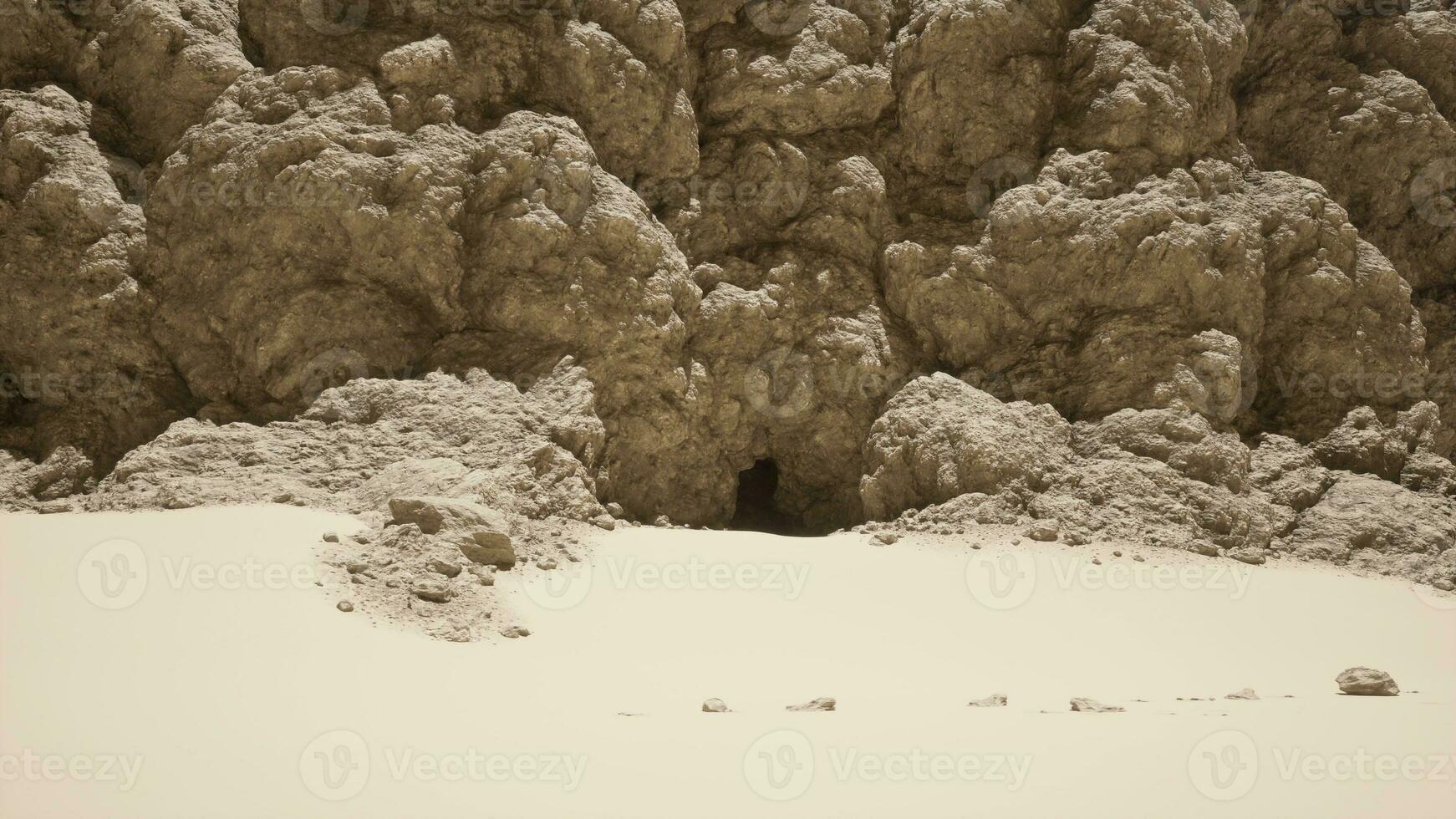 A group of rocks on a sandy beach photo