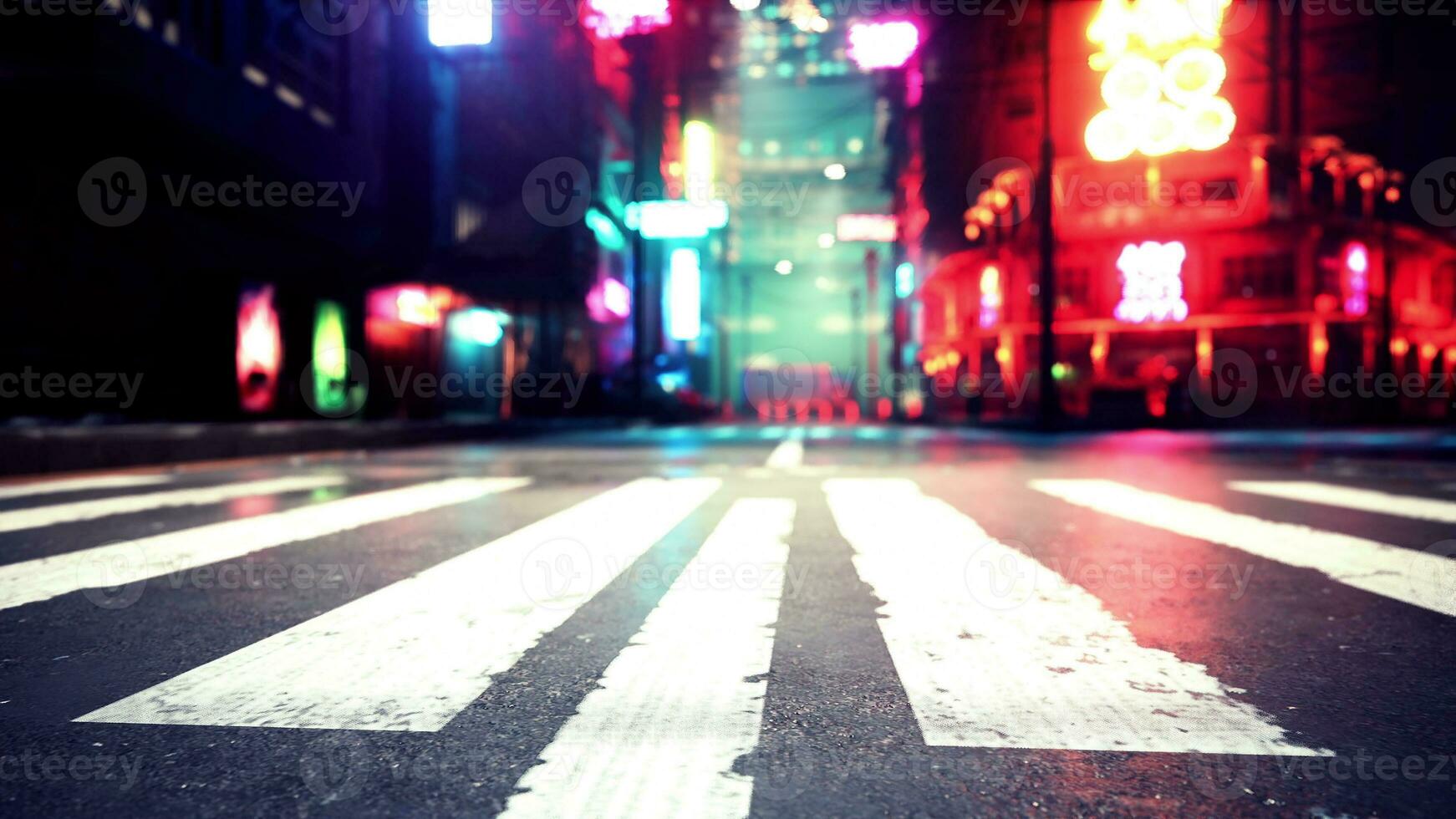 A city street with a crosswalk at night photo