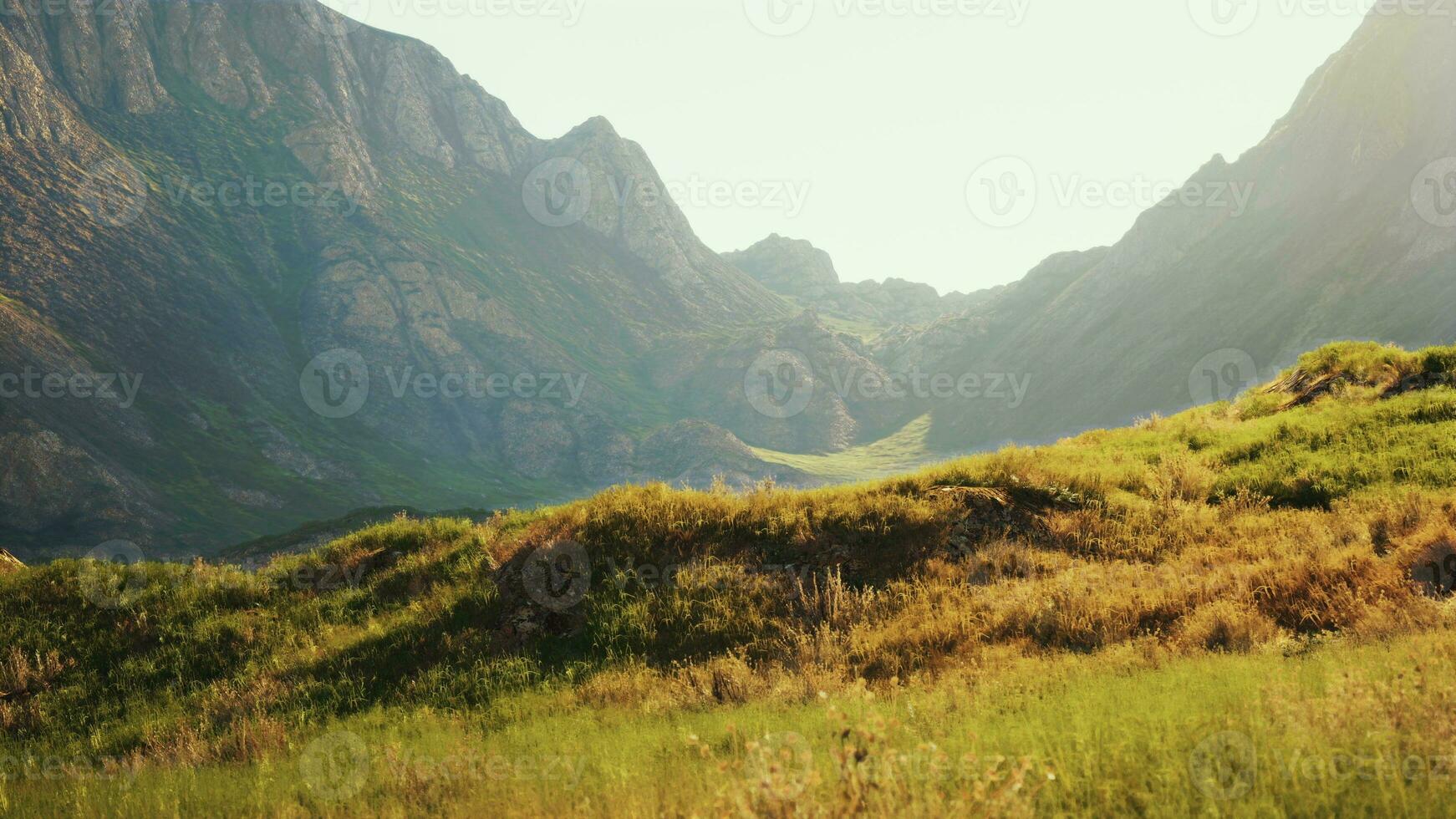 highland plateau in the foggy dawn between rocky mountains photo
