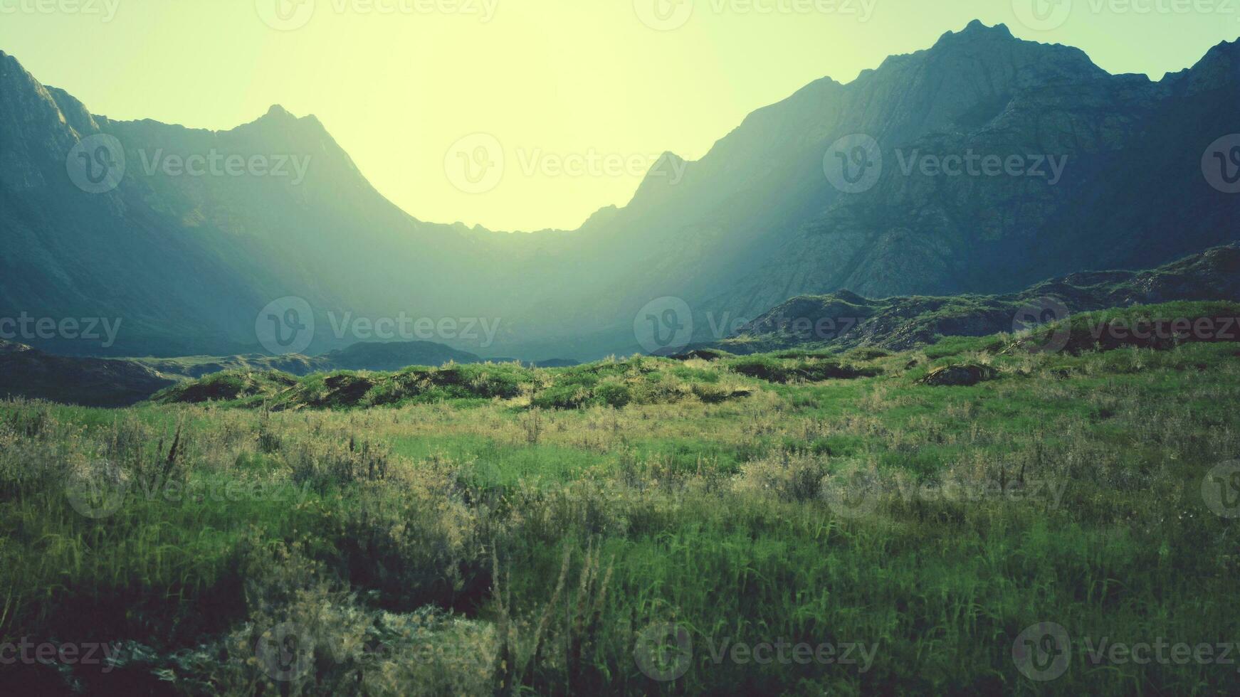 barren rocky mountain scene with dry grass and scattered stones photo