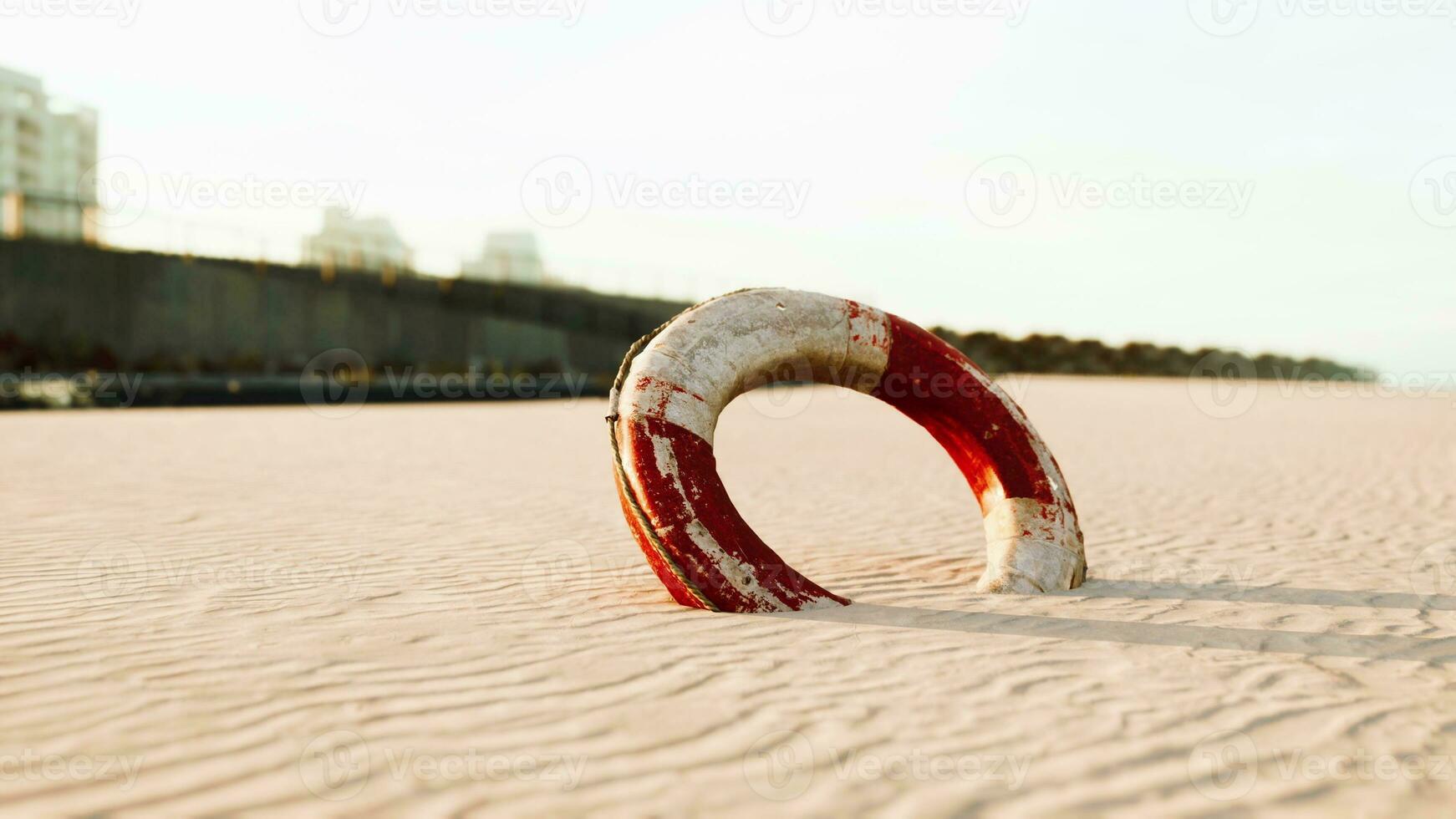 Lifebuoy on the city beach at sunset photo