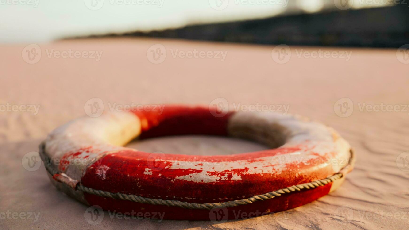 Lifebuoy on the city beach at sunset photo