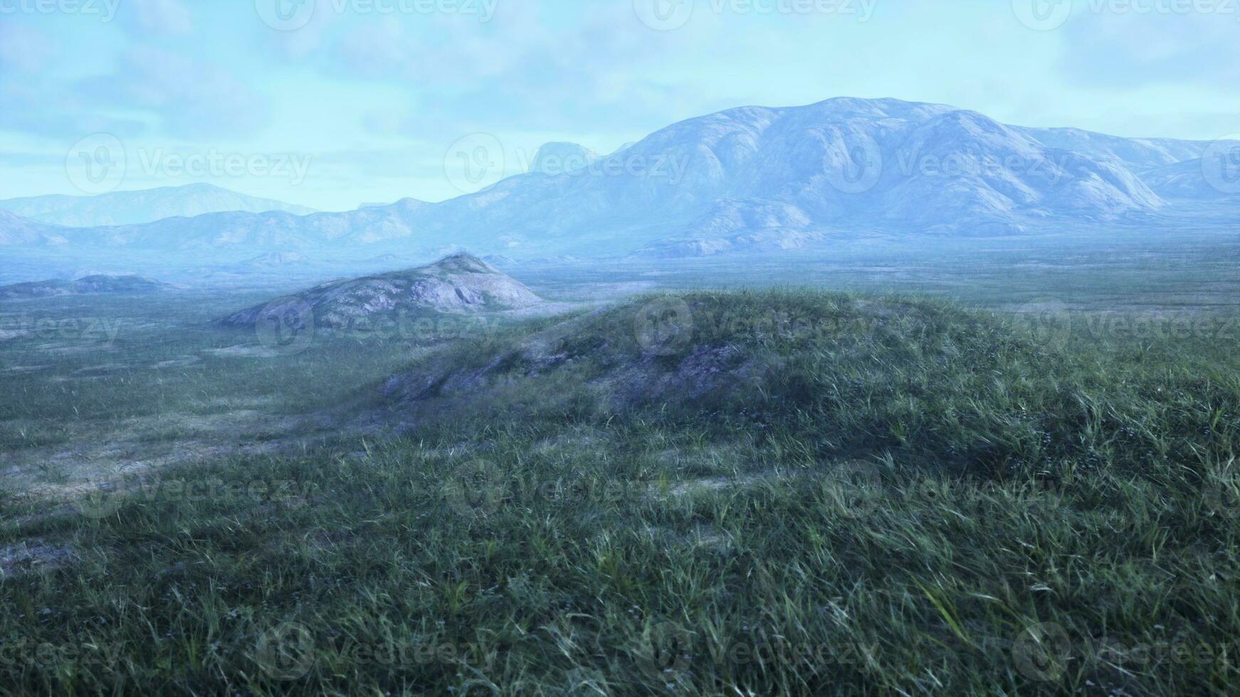 landscape with rolling hills and majestic mountains in the distance photo