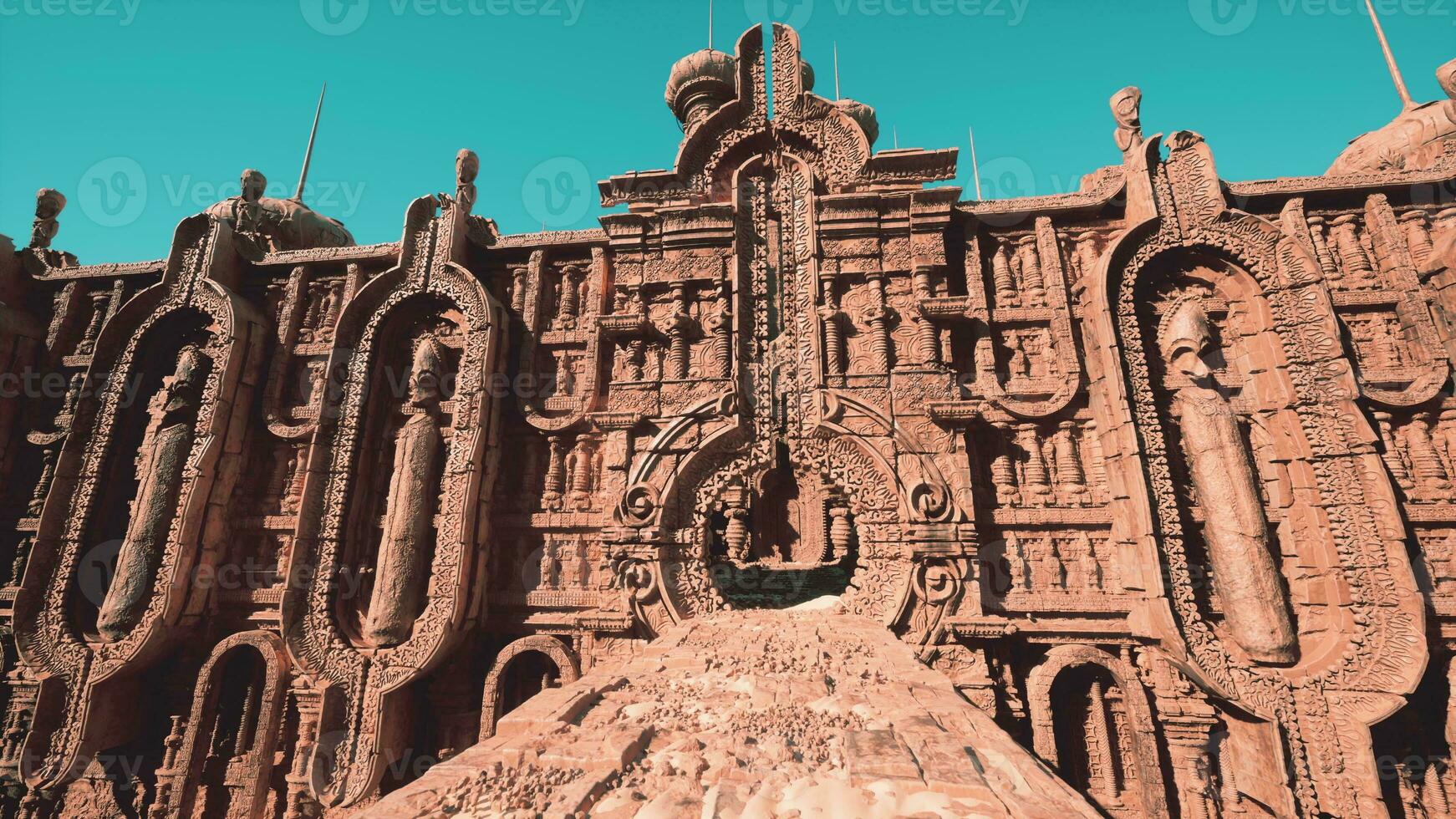 A red clay temple with intricate ornamented walls photo